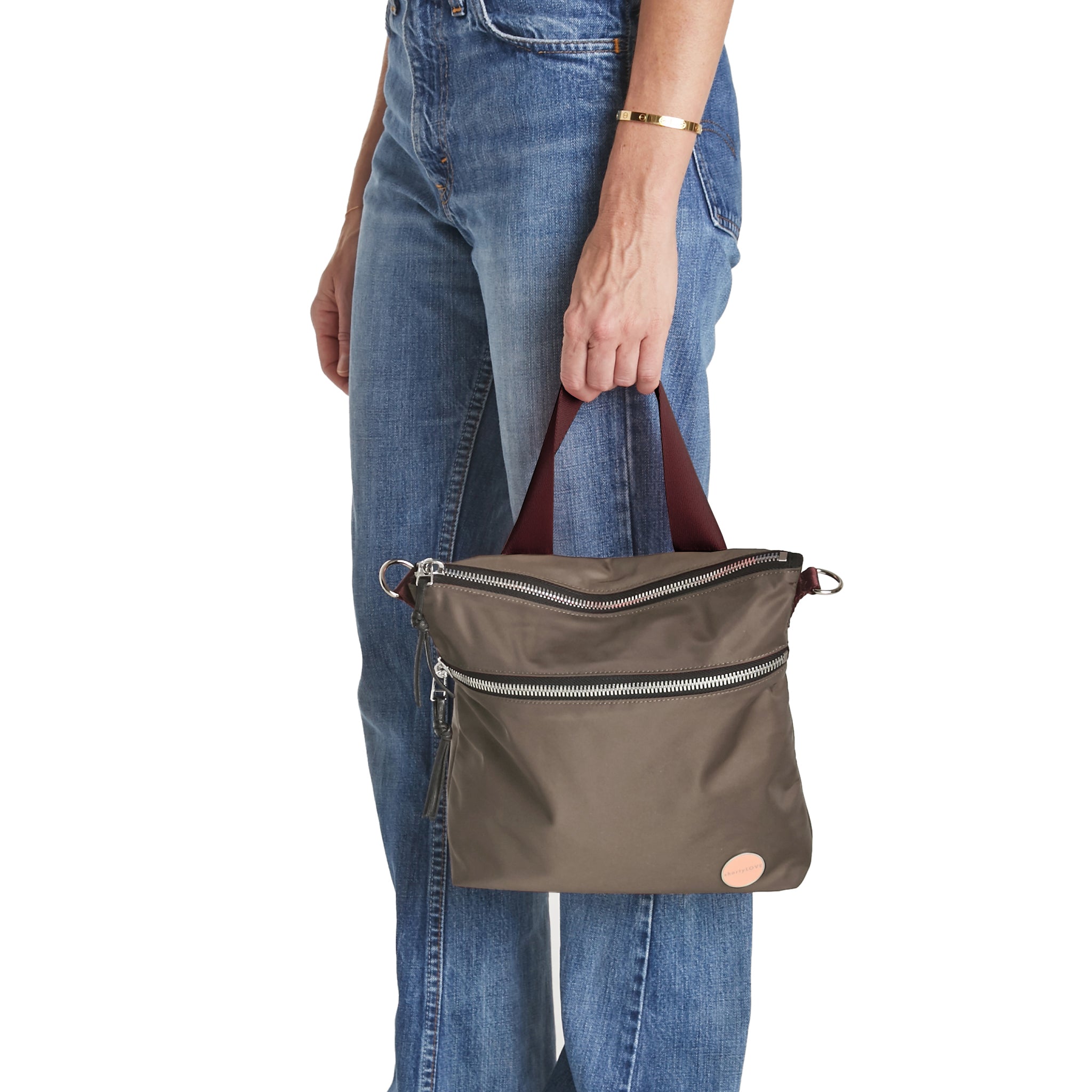 shortyLOVE amuse medium sized crossbody bag in mocha; hand held by model.