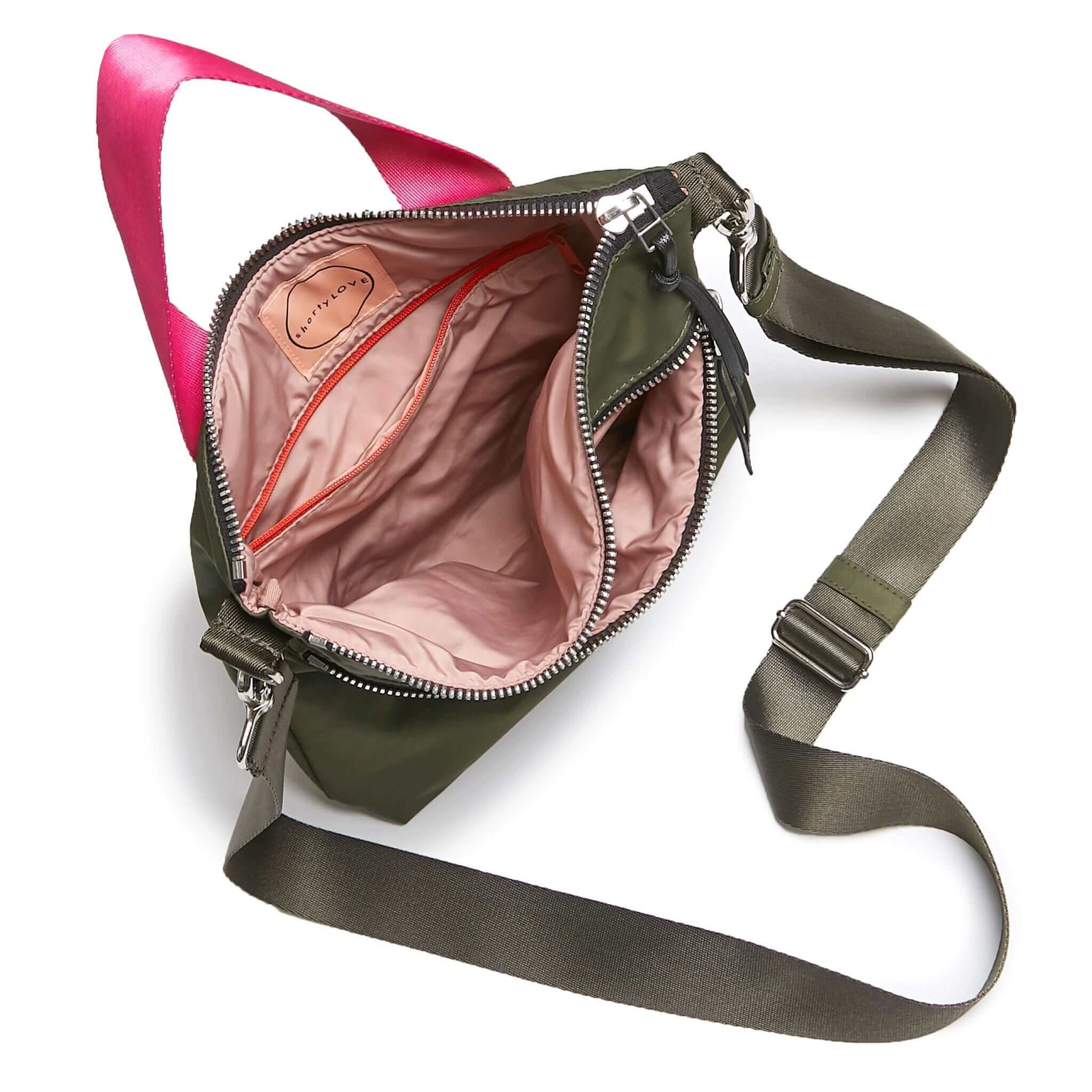shortyLOVE amuse medium sized crossbody bag in army green; top-down view showing interior pink lining against white background.