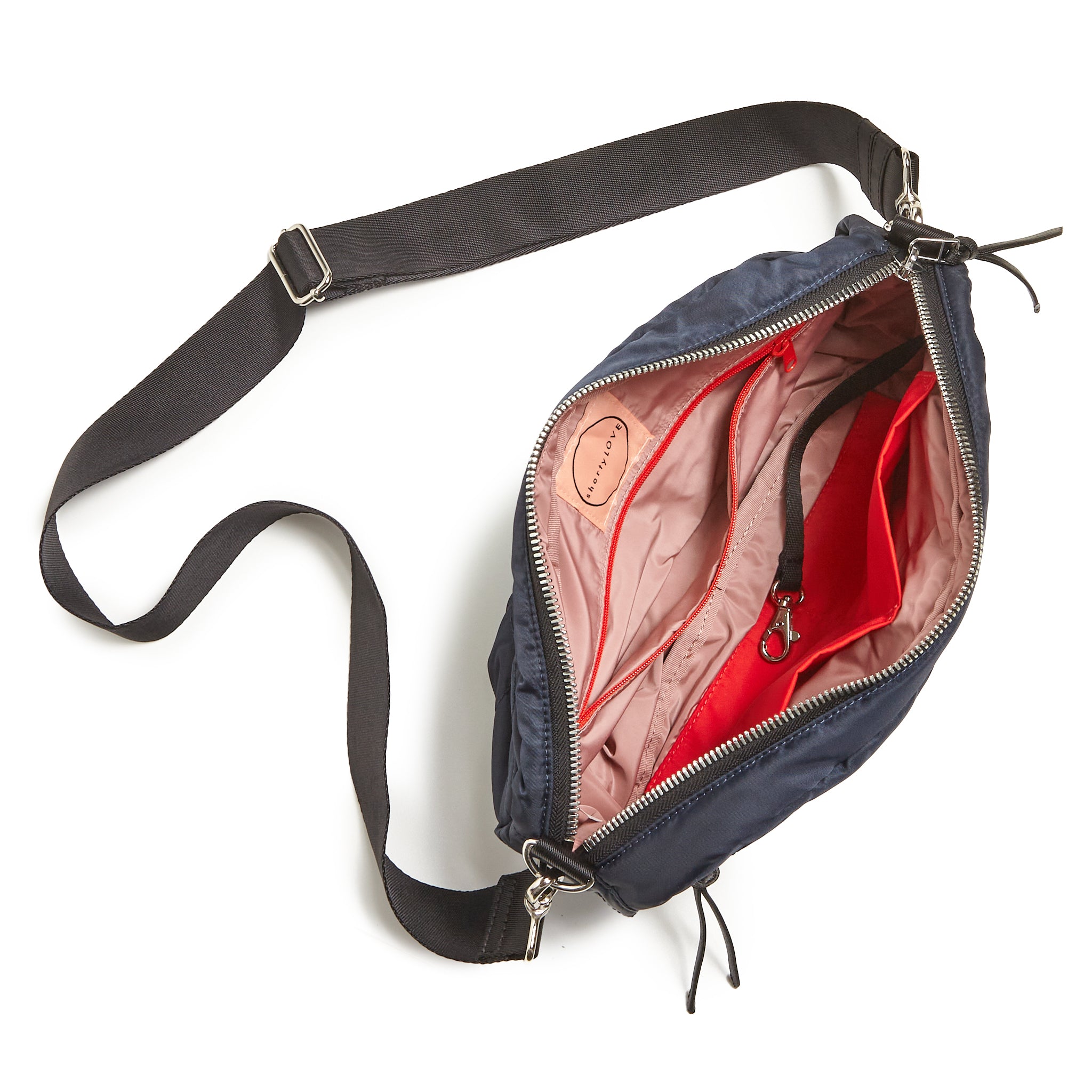 shortyLOVE cruiser medium crossbody bag in midnight; top-down view showing interior blush lining against white background.