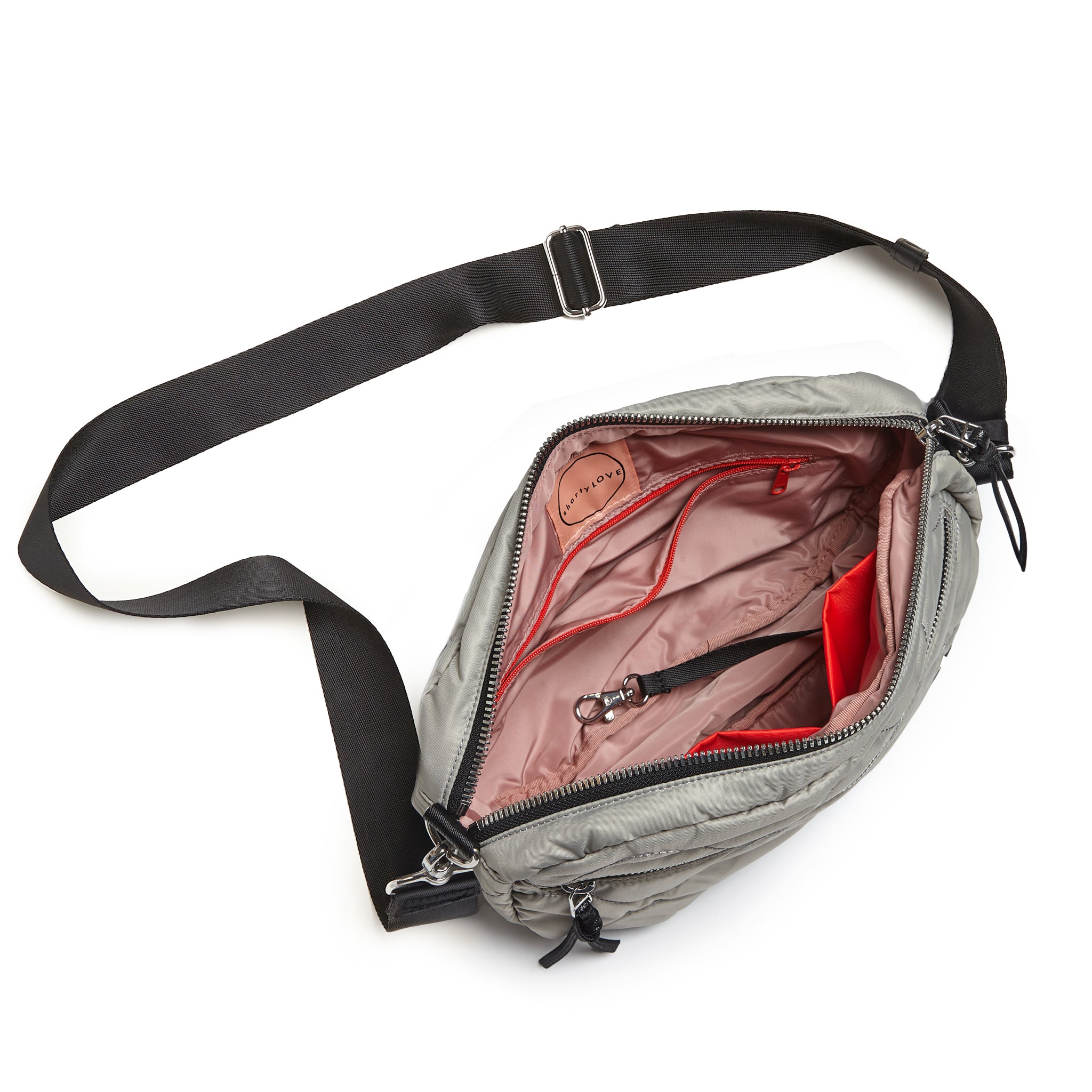 shortyLOVE cruiser medium crossbody bag in milky grey; top-down view showing interior blush lining against white background.