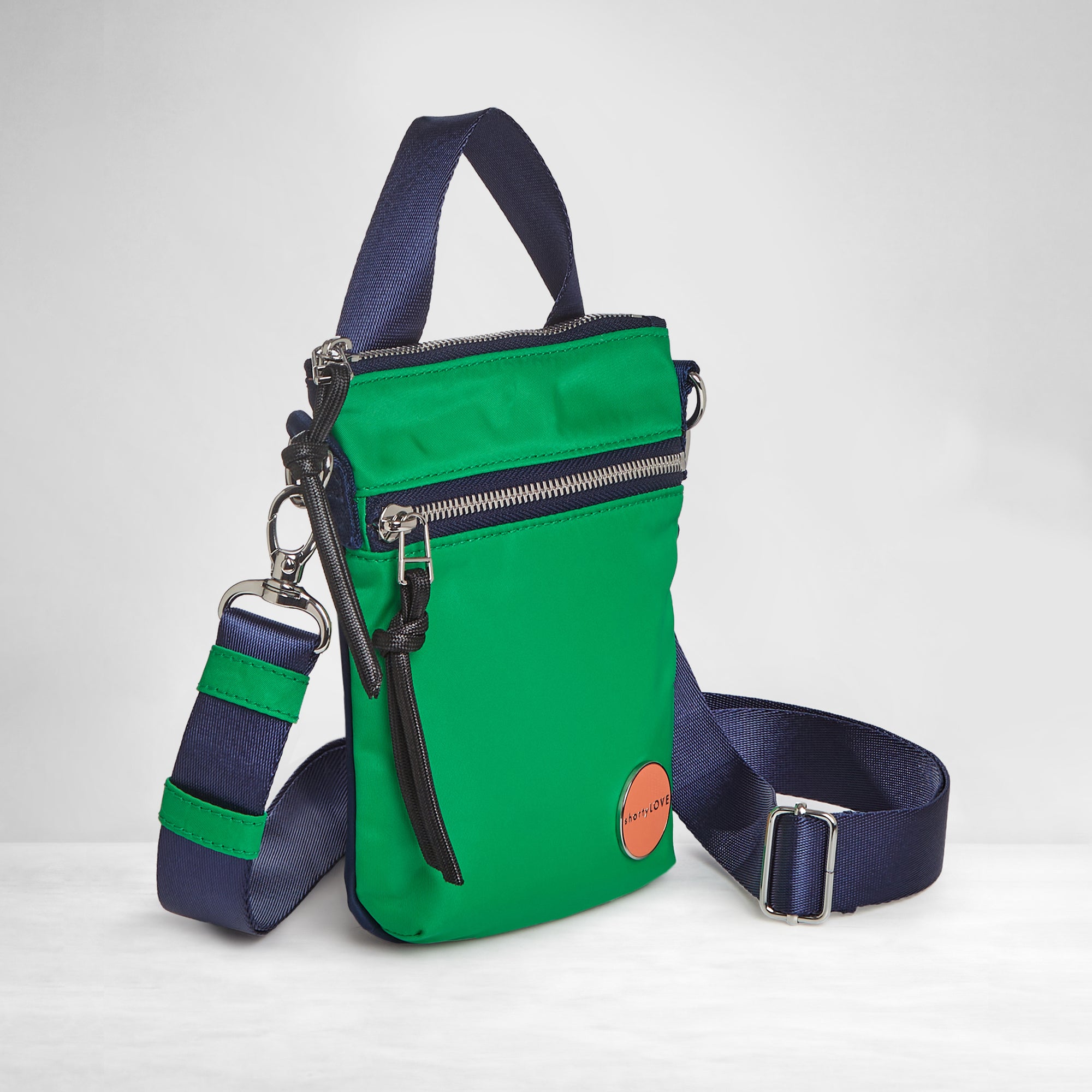 shortyLOVE shorthand small crossbody bag in grass green/navy; side angle view against white background.
