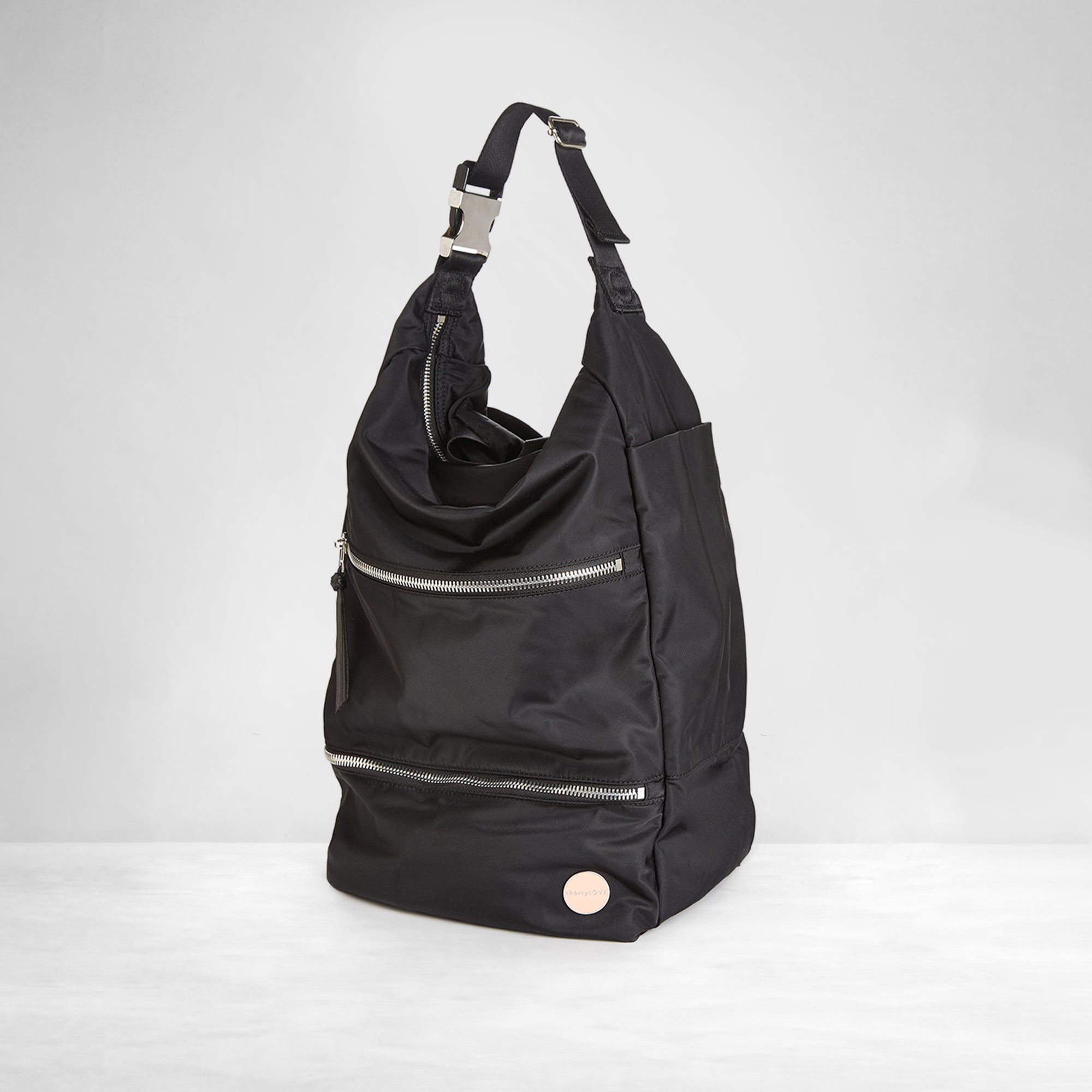 shortyLOVE boxer backpack bag in black; side angle view against white background.