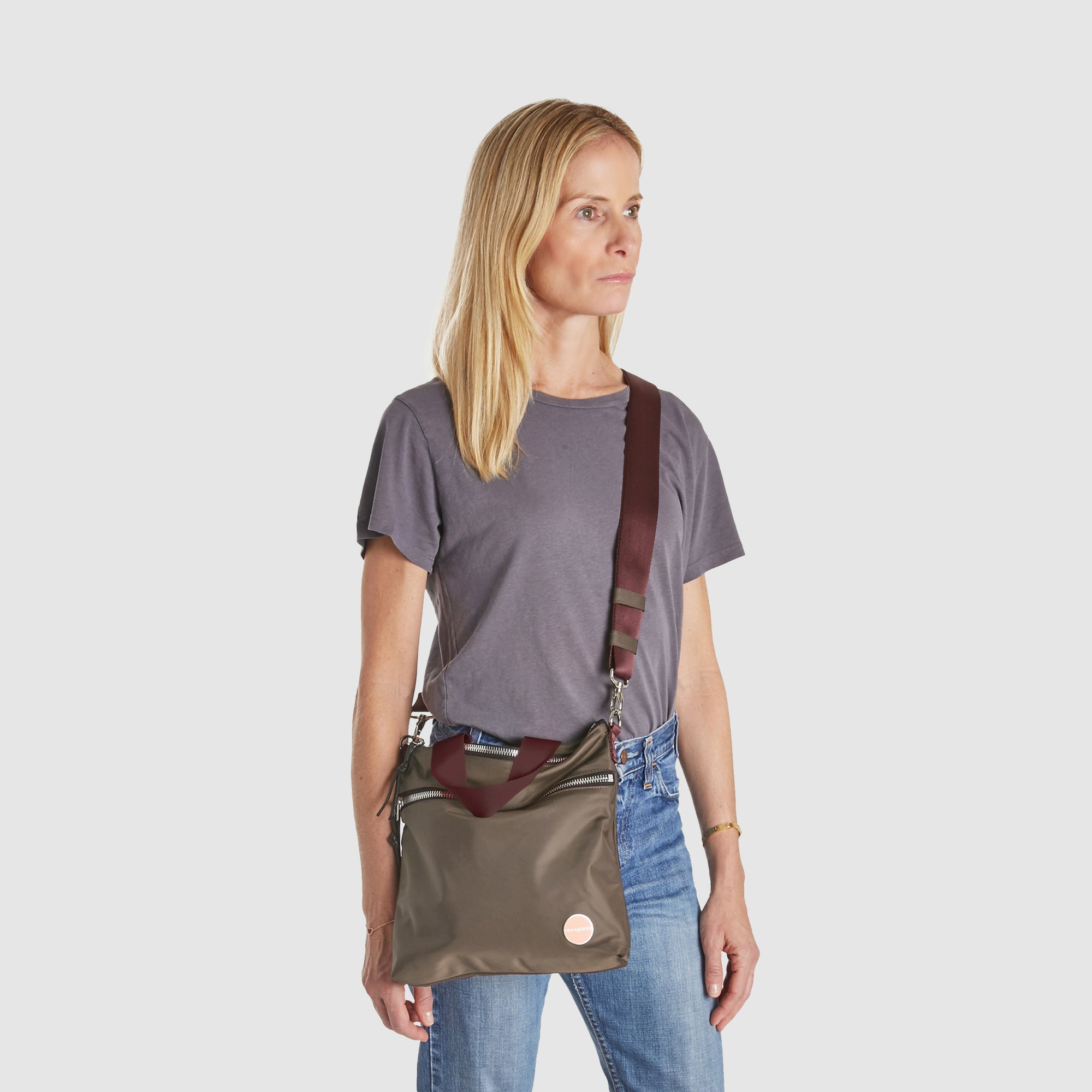 shortyLOVE amuse medium sized crossbody bag in mocha; worn crossbody by model.
