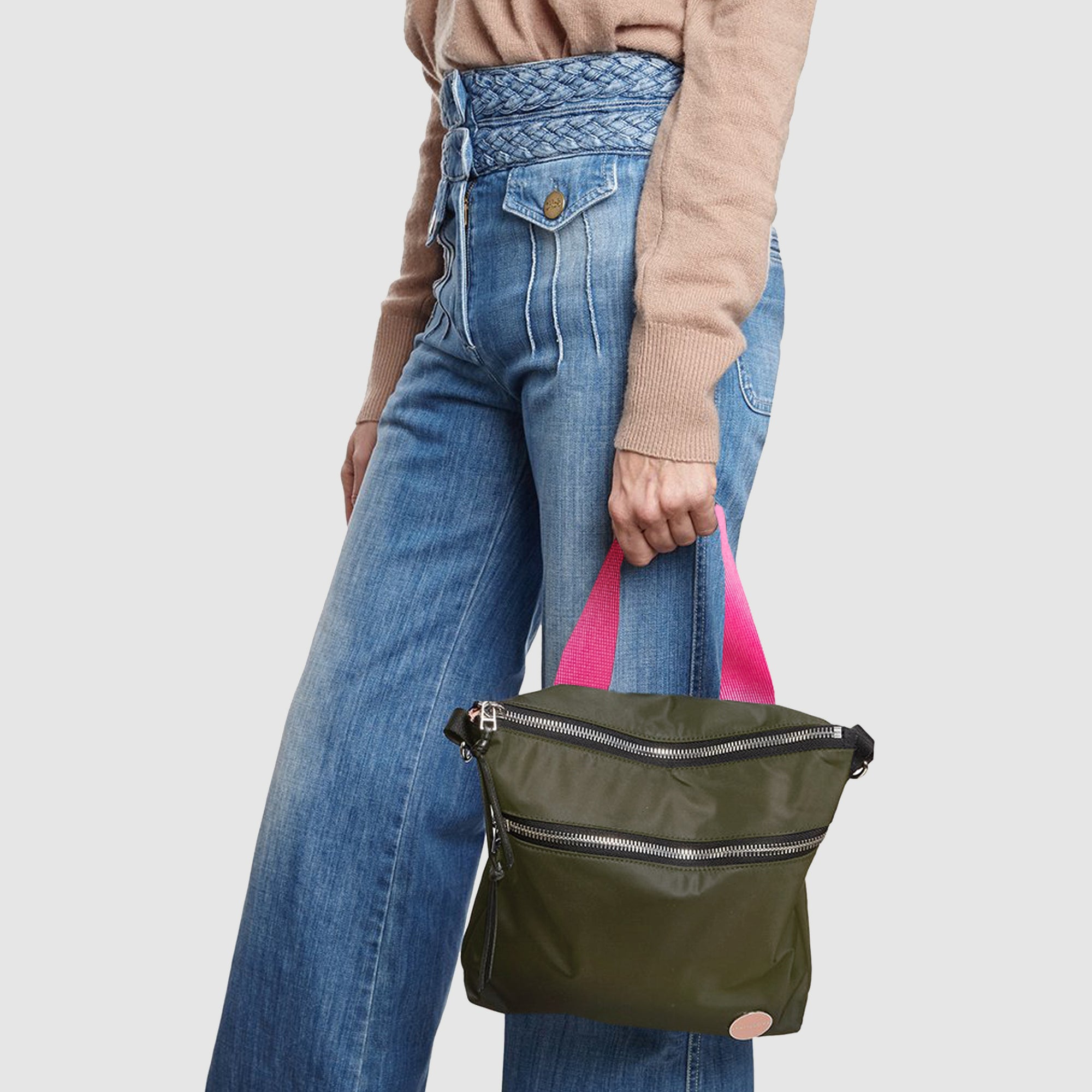 shortyLOVE amuse medium sized crossbody bag in army green; on model in tan v-neck long sleeve sweater and jeans against white background.