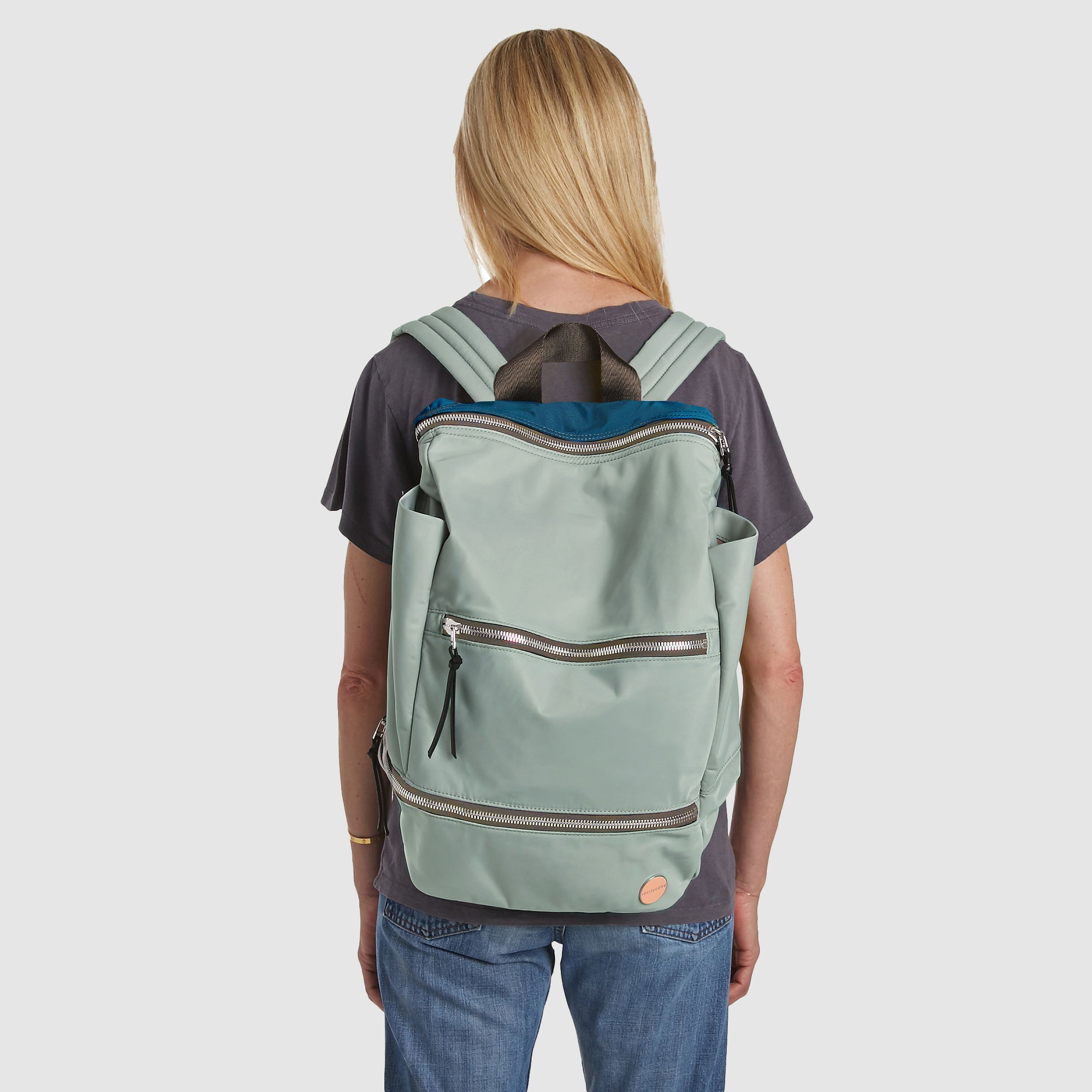 shortyLOVE boxer backpack in slate/teal; on back of model in grey t-shirt and jeans against white background.