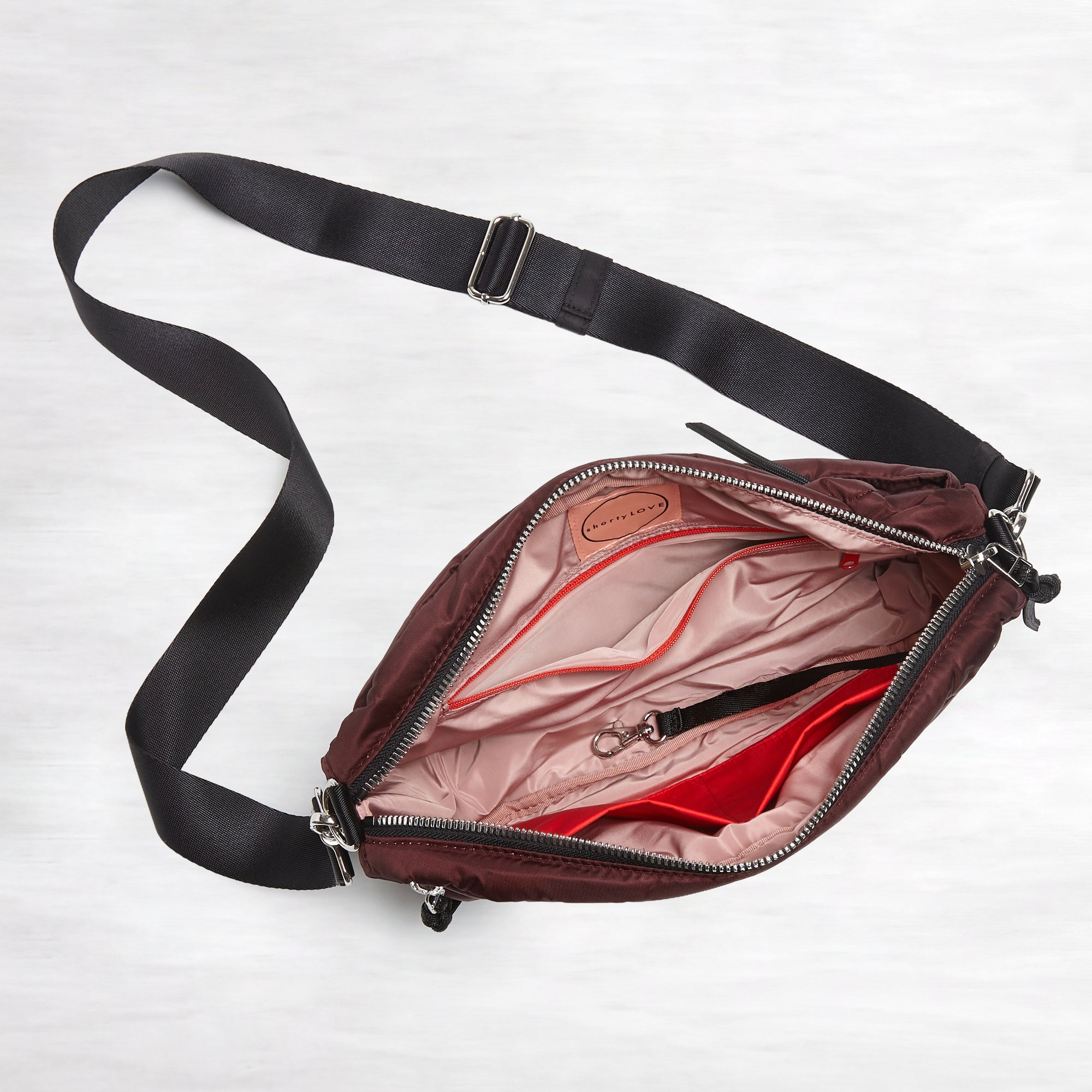 shortyLOVE cruiser medium crossbody bag in bordeaux; top down view against white background.