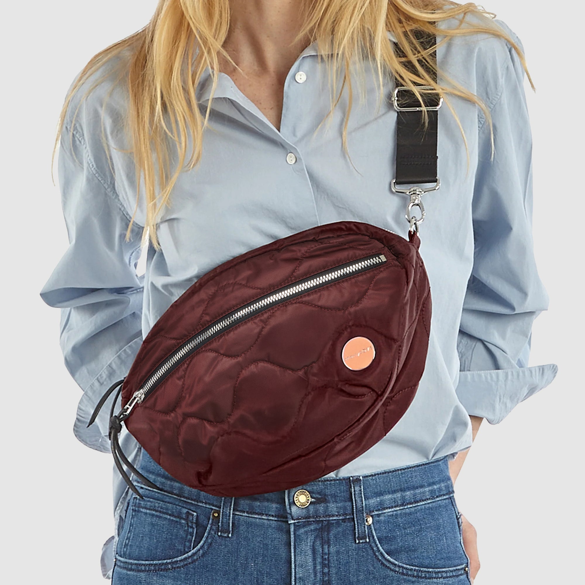 shortyLOVE cruiser medium crossbody bag in bordeaux on model in blue top and jeans.