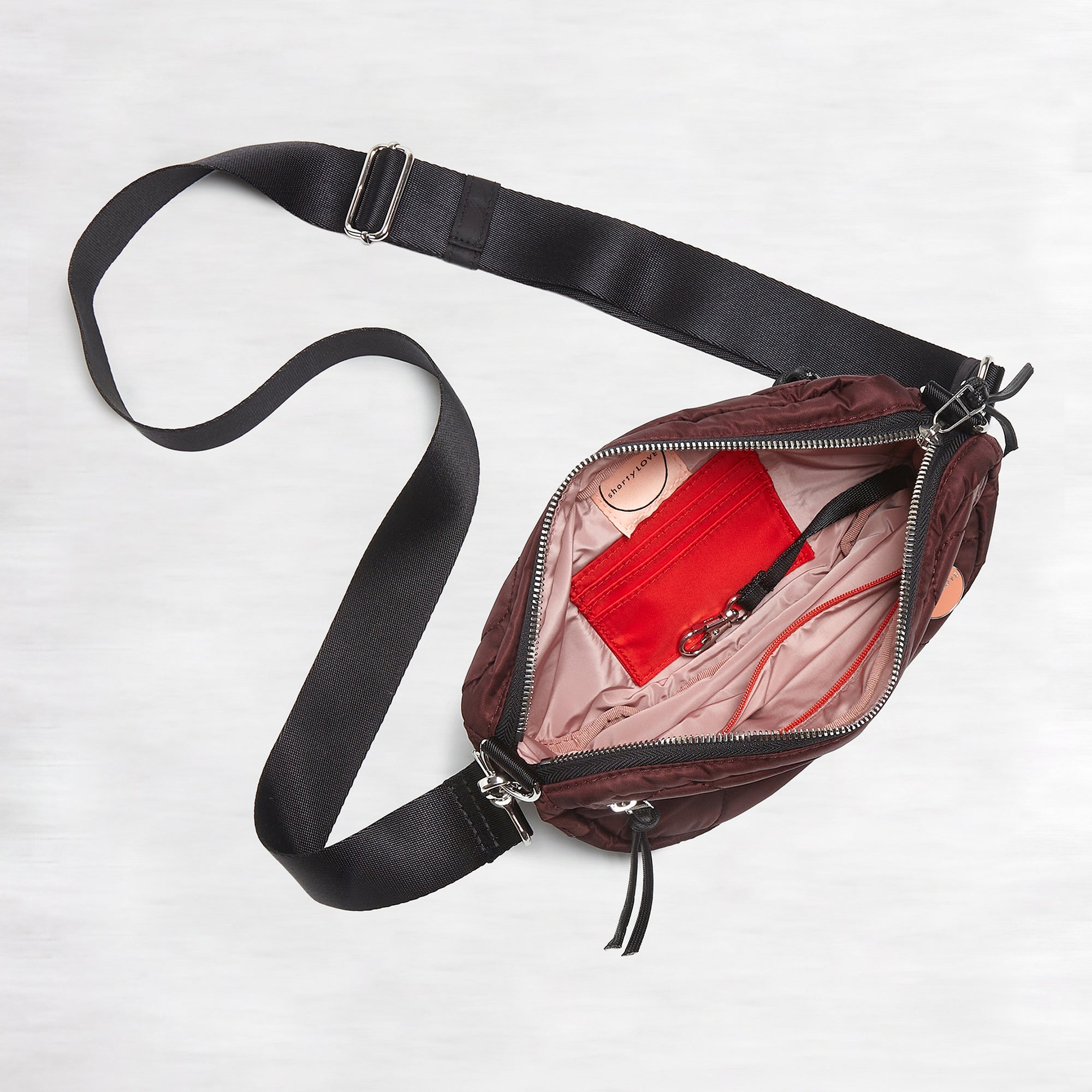 shortyLOVE small cruiser small crossbody bag in bordeaux; top view against white background.