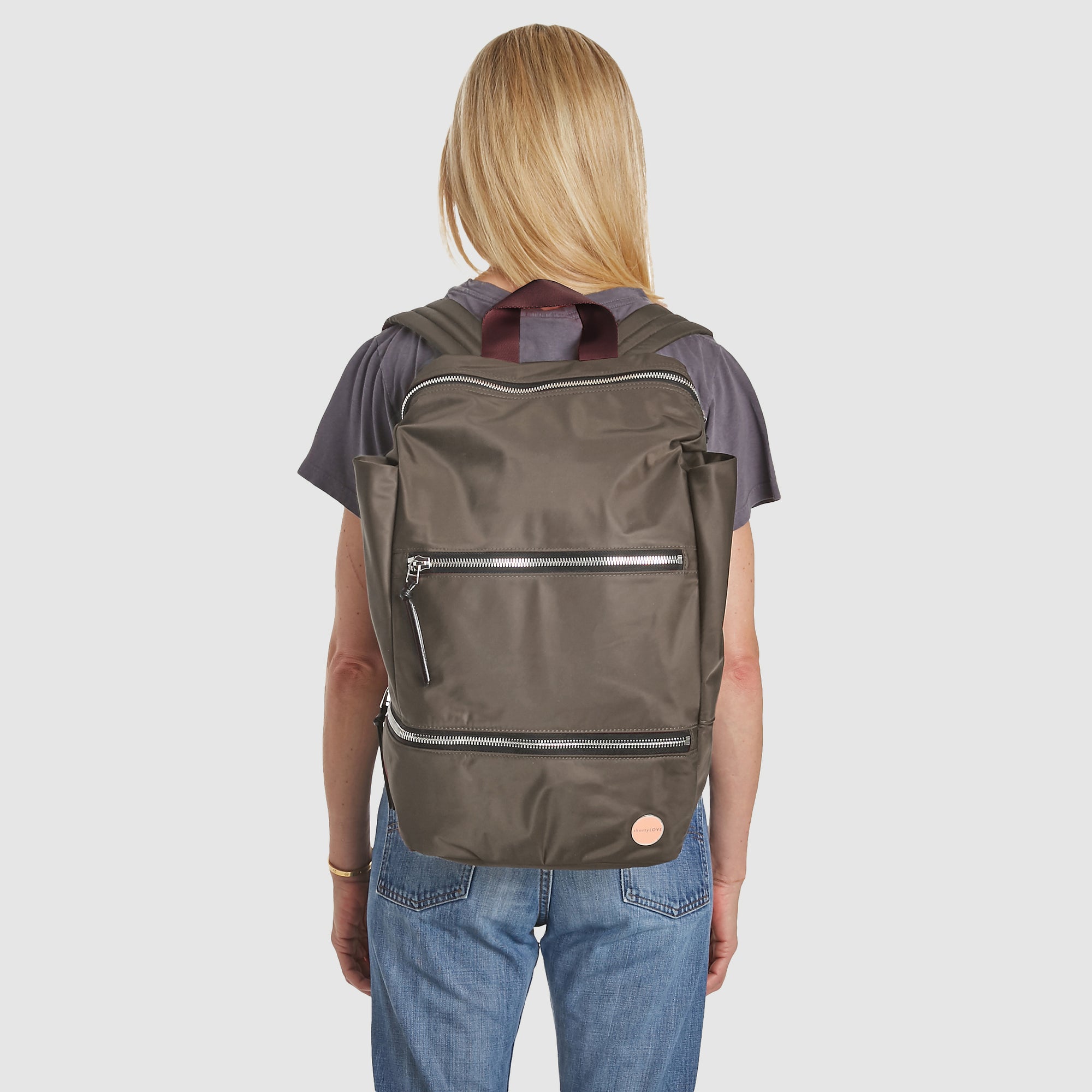 shortyLOVE boxer backpack in mocha; on model on back in grey t-shirt and jeans against white background.