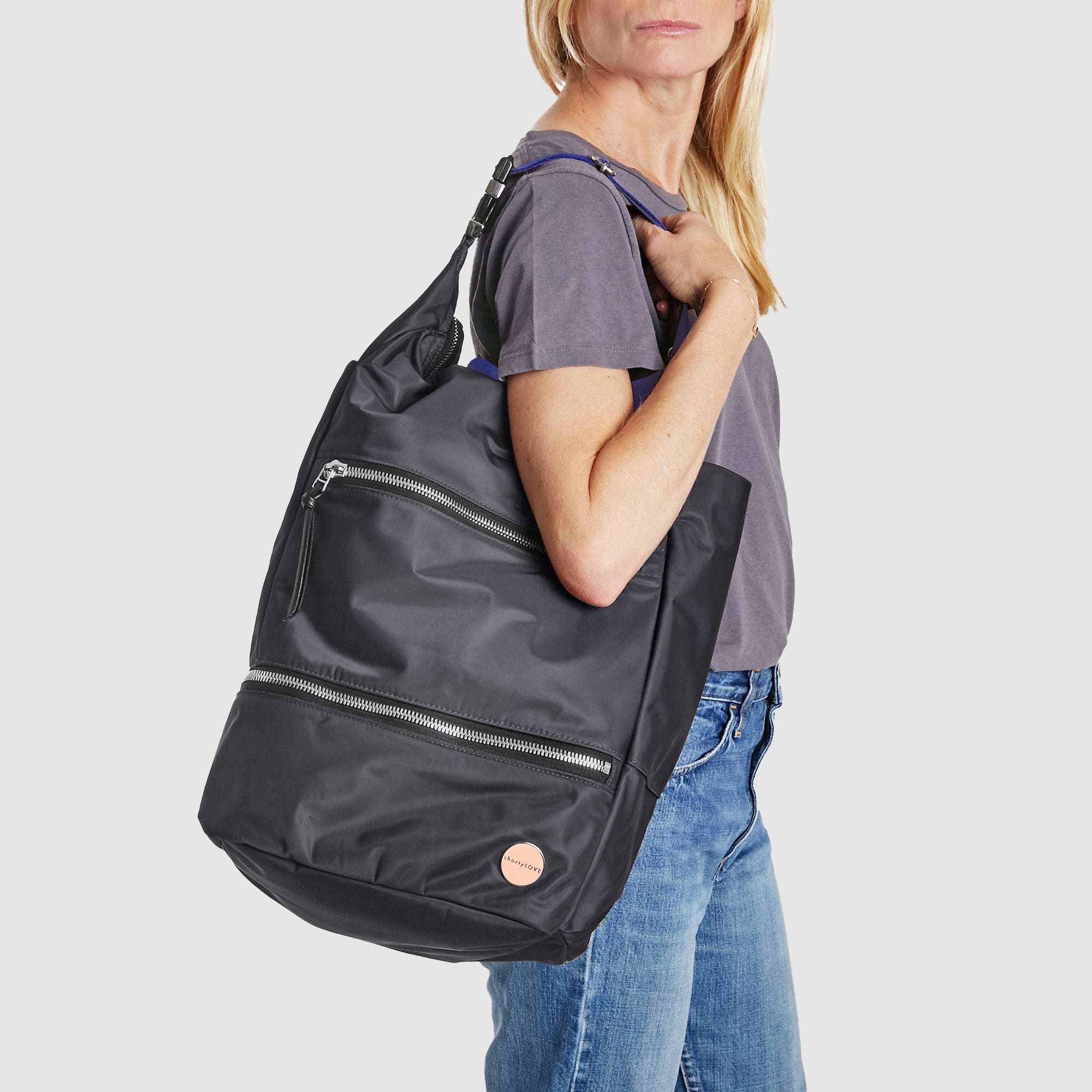 shortyLOVE boxer backpack in charcoal; on model over shoulder in grey t-shirt and jeans against white background.