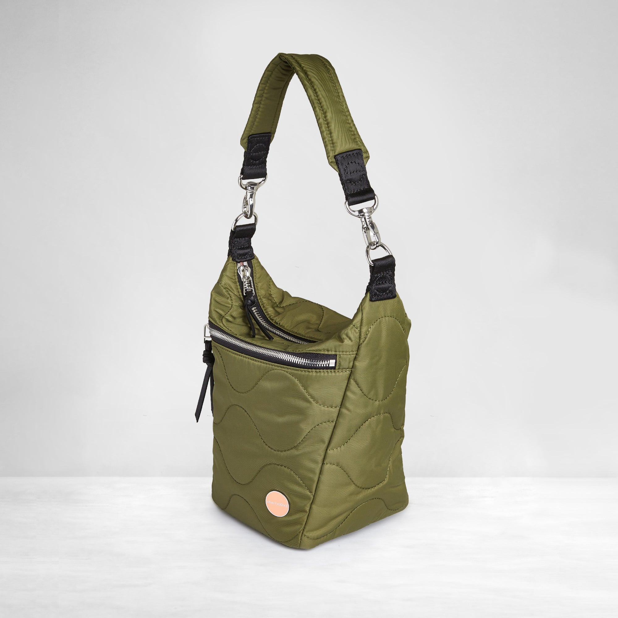 shortyLOVE marcel crossbody bucket bag in sage; side view against white background.