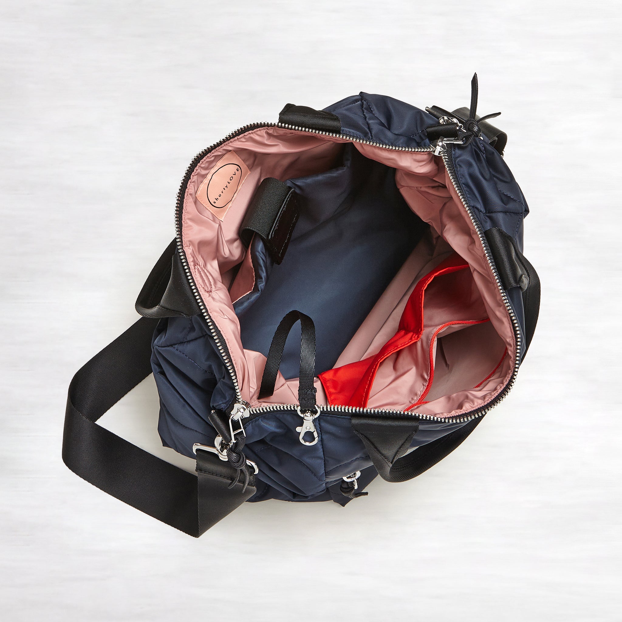 shortyLOVE ranger large tote bag in midnight; top-down view showing interior blush lining against white background.