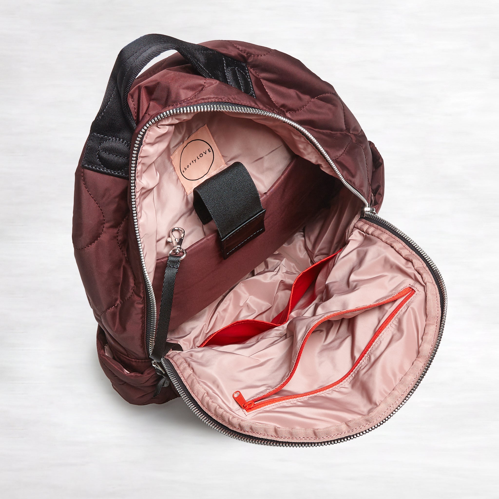shortyLOVE tate backpack in bordeaux; open top down view against white background