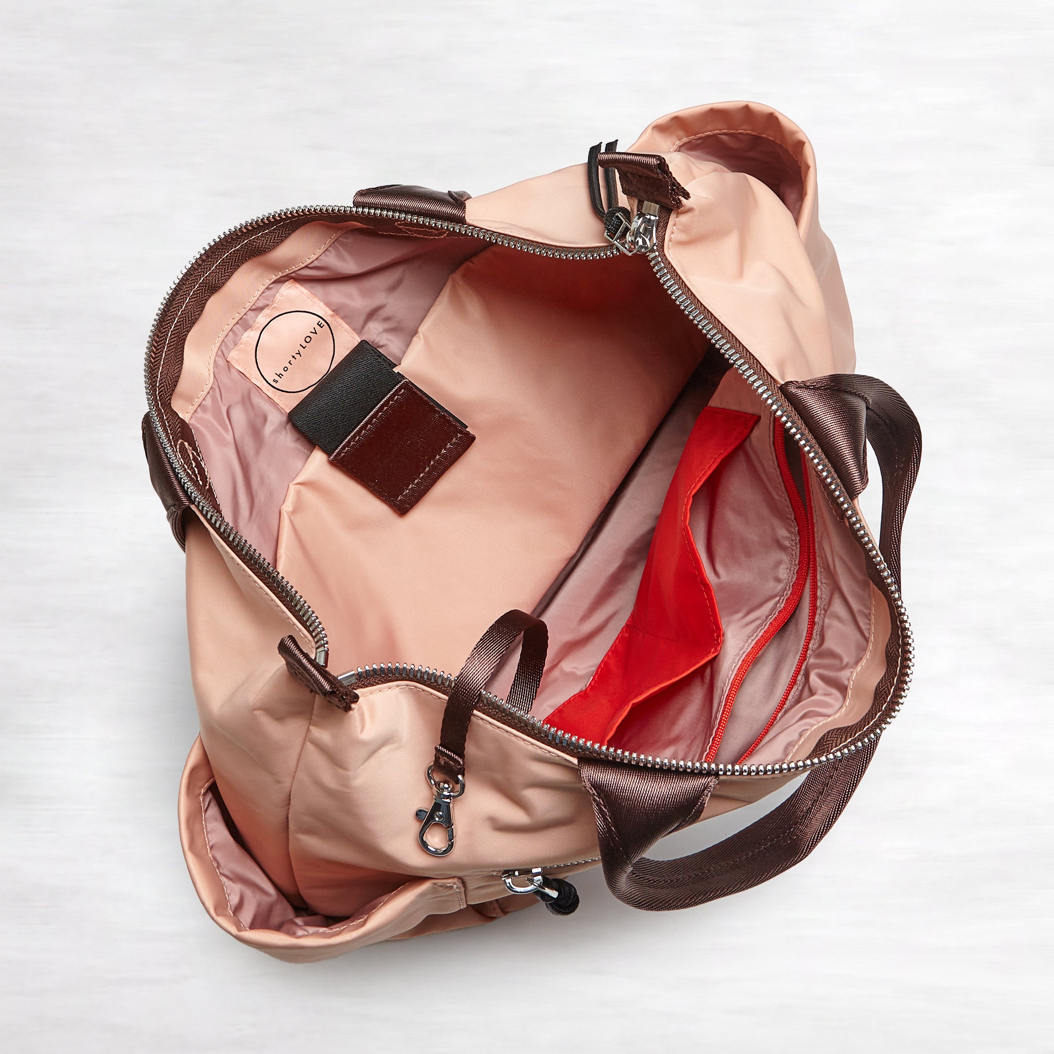 shortyLOVE tillie tote bag in dusty peach; top-down view showing interior blush/red lining against white background.