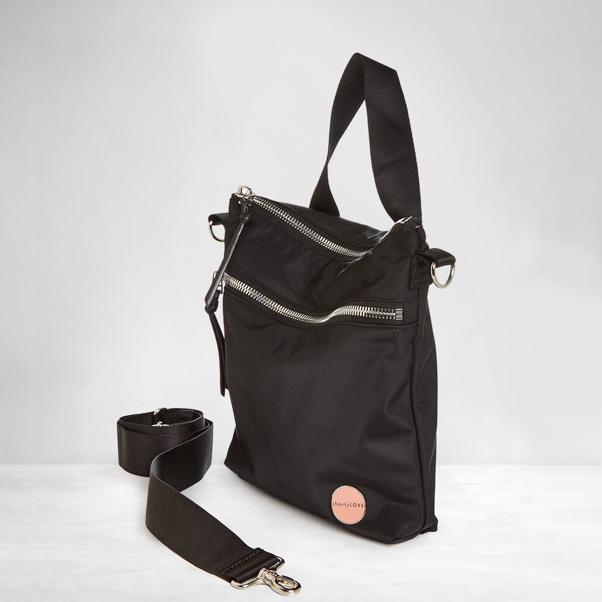 shortyLOVE amuse medium sized crossbody bag in black; side angle view against white background.