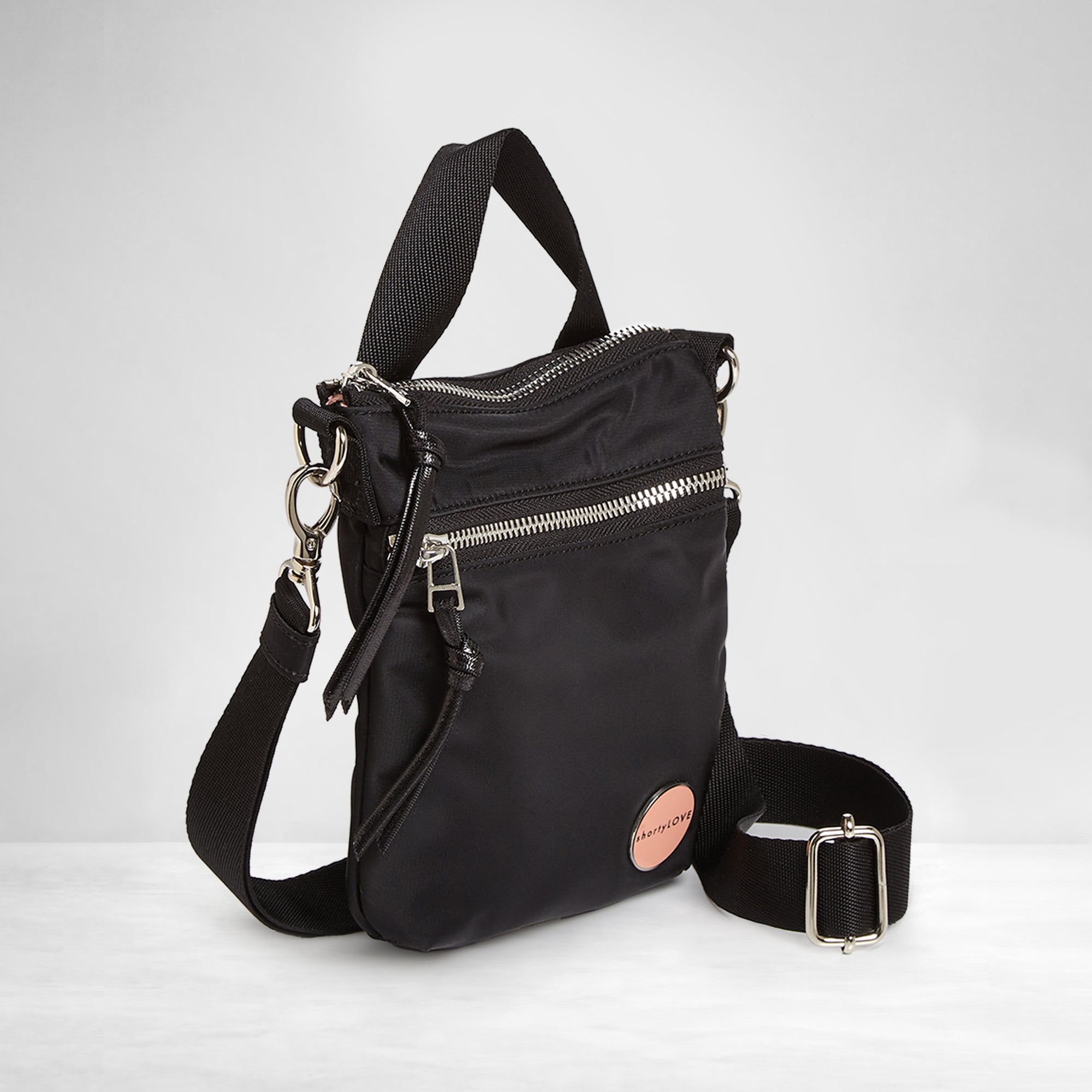 shortyLOVE shorthand crossbody phone bag in black; side angle view against white background