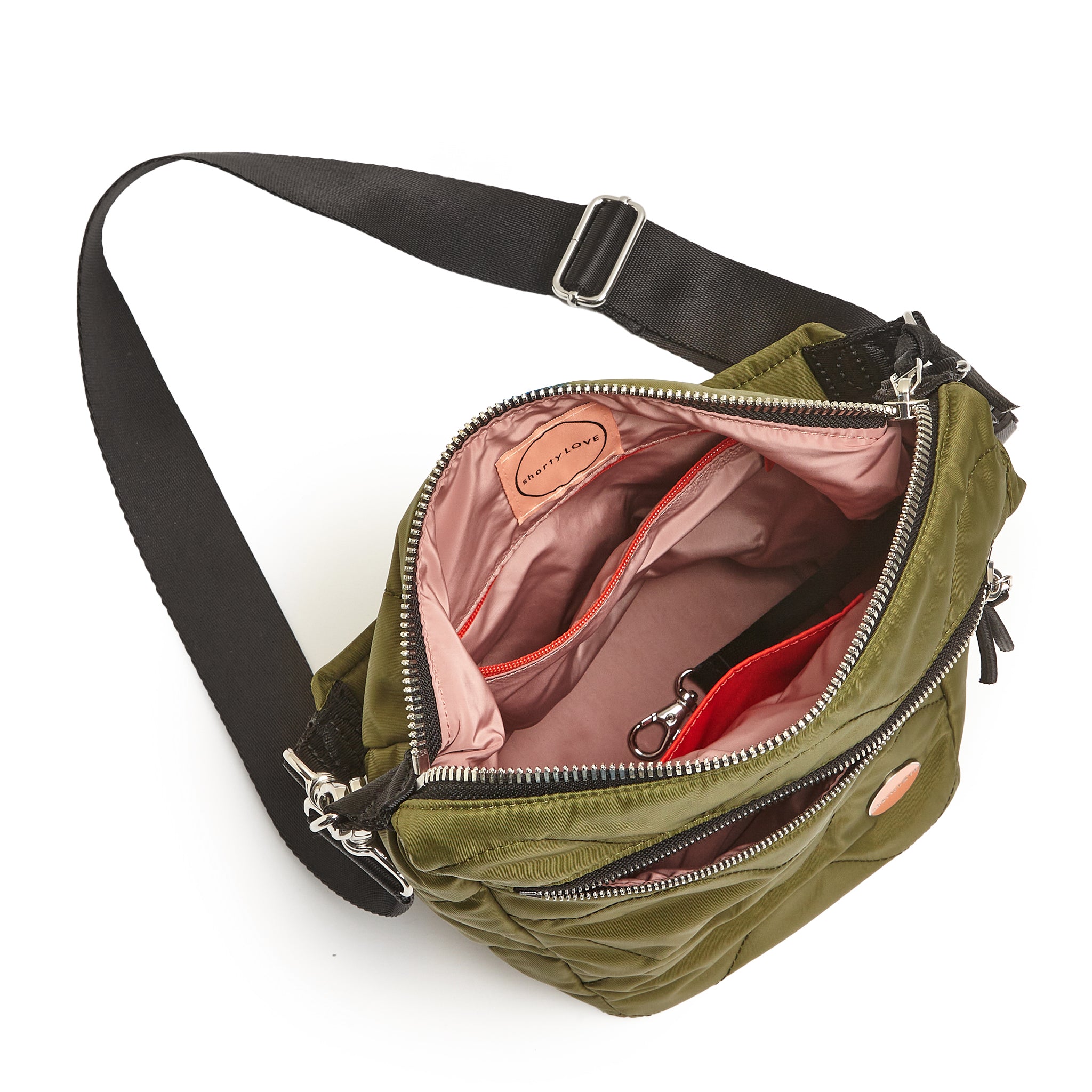 shortyLOVE marcel crossbody bucket bag in sage; top-down view showing interior blush lining against white background.