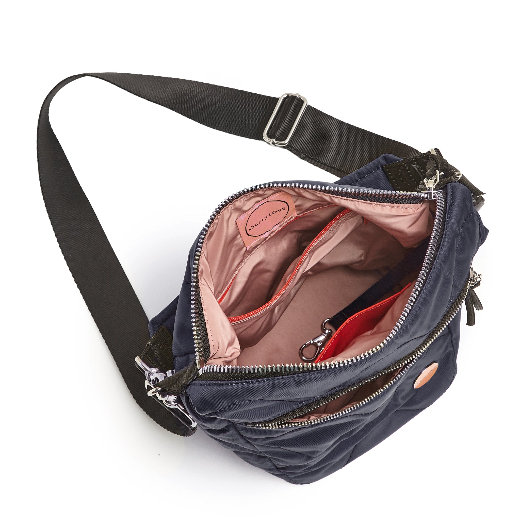 shortyLOVE marcel crossbody bucket bag in midnight; top-down view showing interior blush lining against white background.