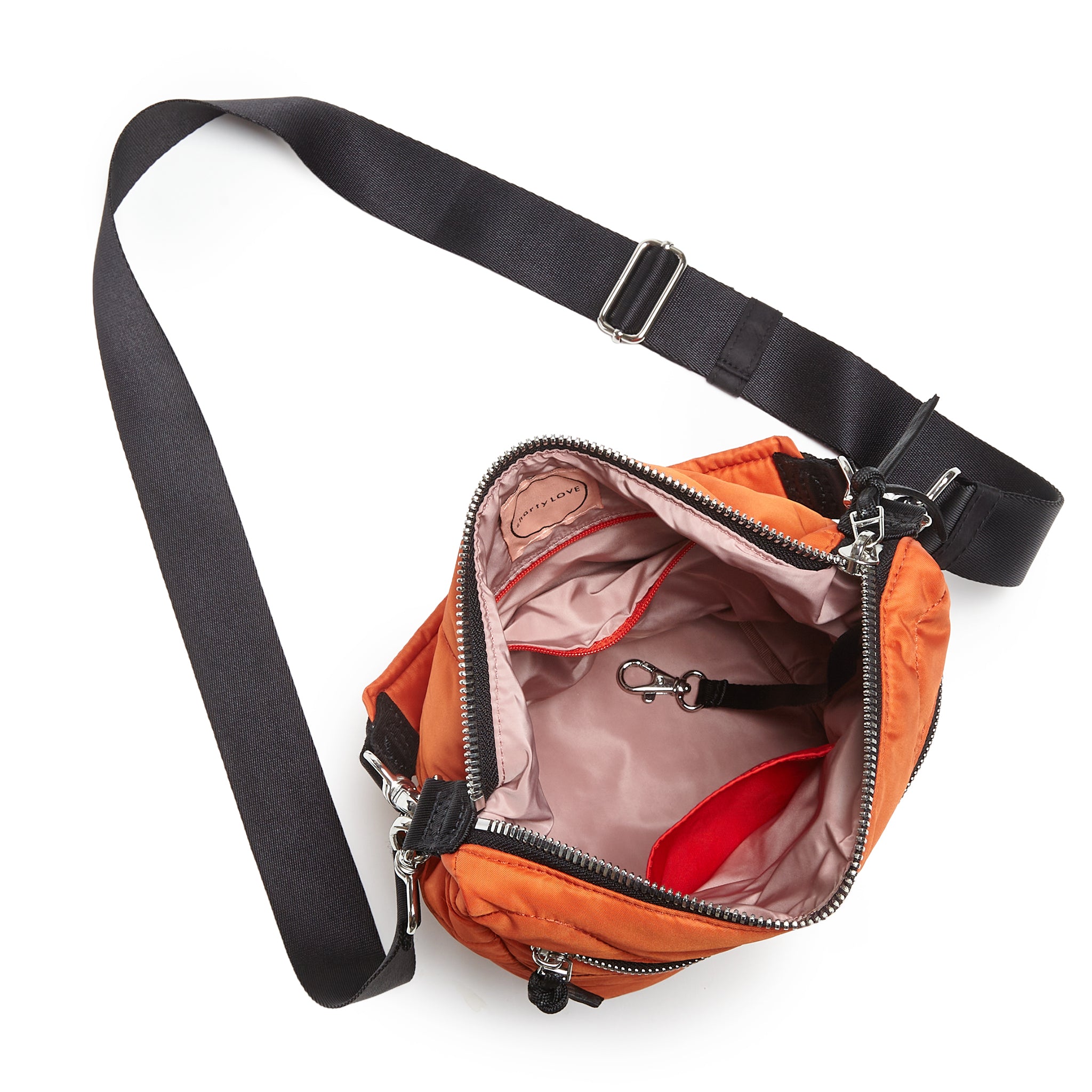 shortyLOVE marcel crossbody bucket bag in orange; top-down view showing interior blush lining against white background.