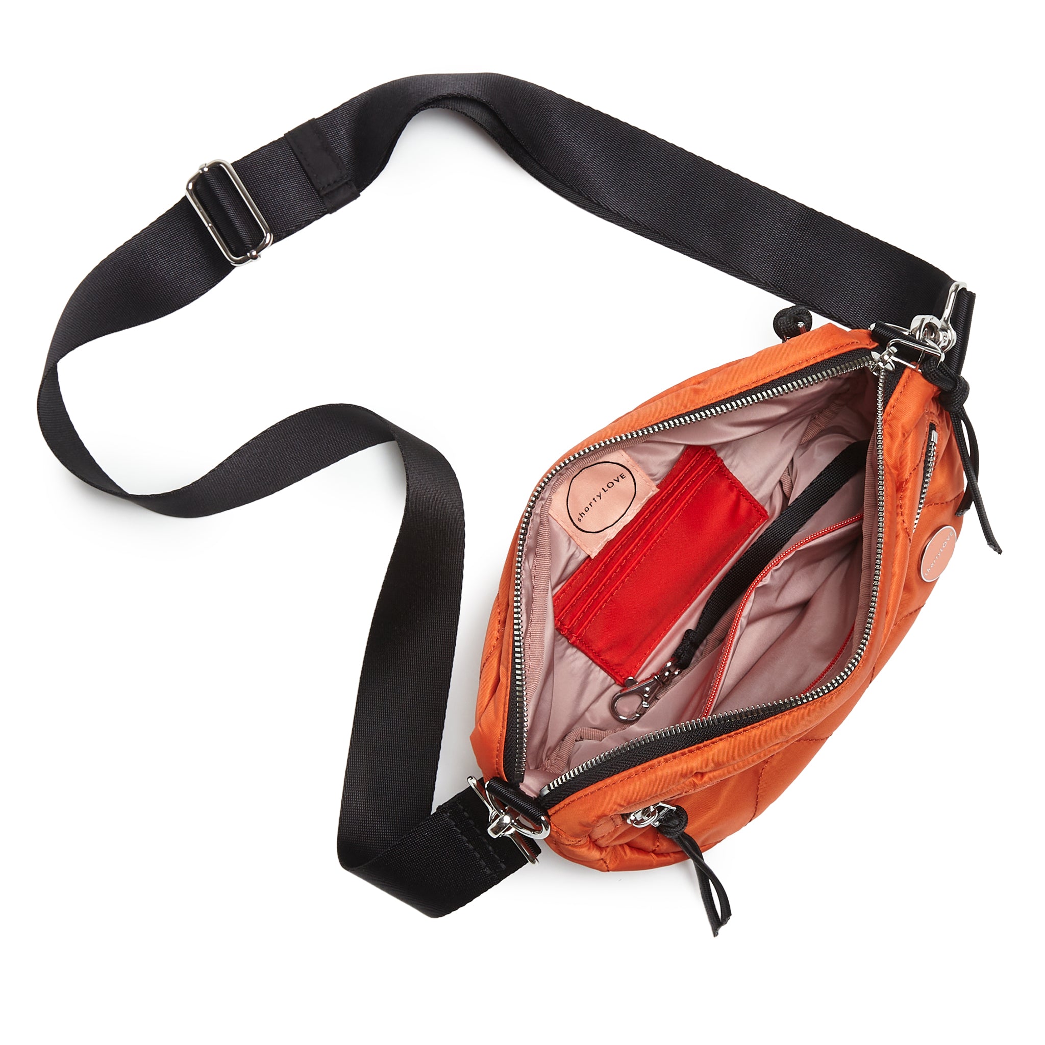 shortyLOVE small cruiser small crossbody bag in orange; top-down view showing interior blush lining against white background.