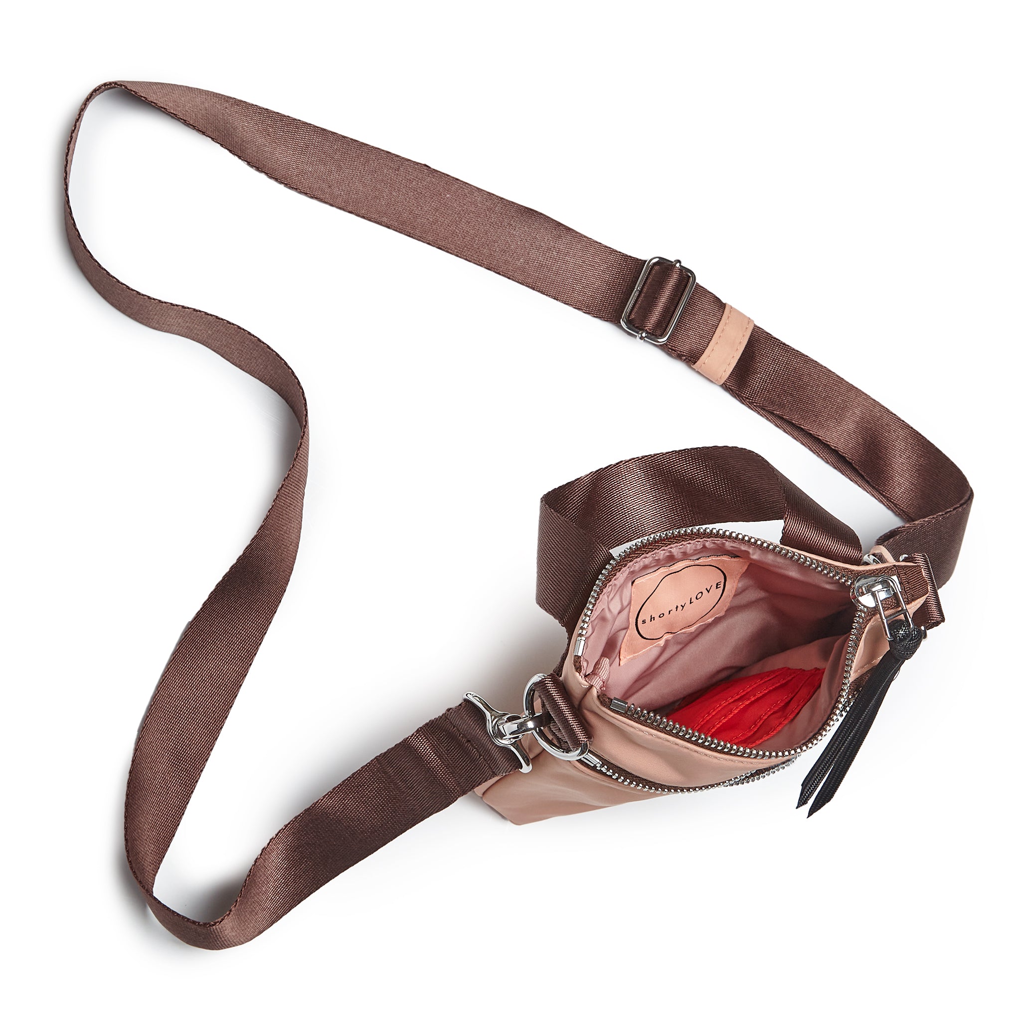 shortyLOVE shorthand small crossbody bag in dusty peach; top-down view showing interior blush/red lining against white background.