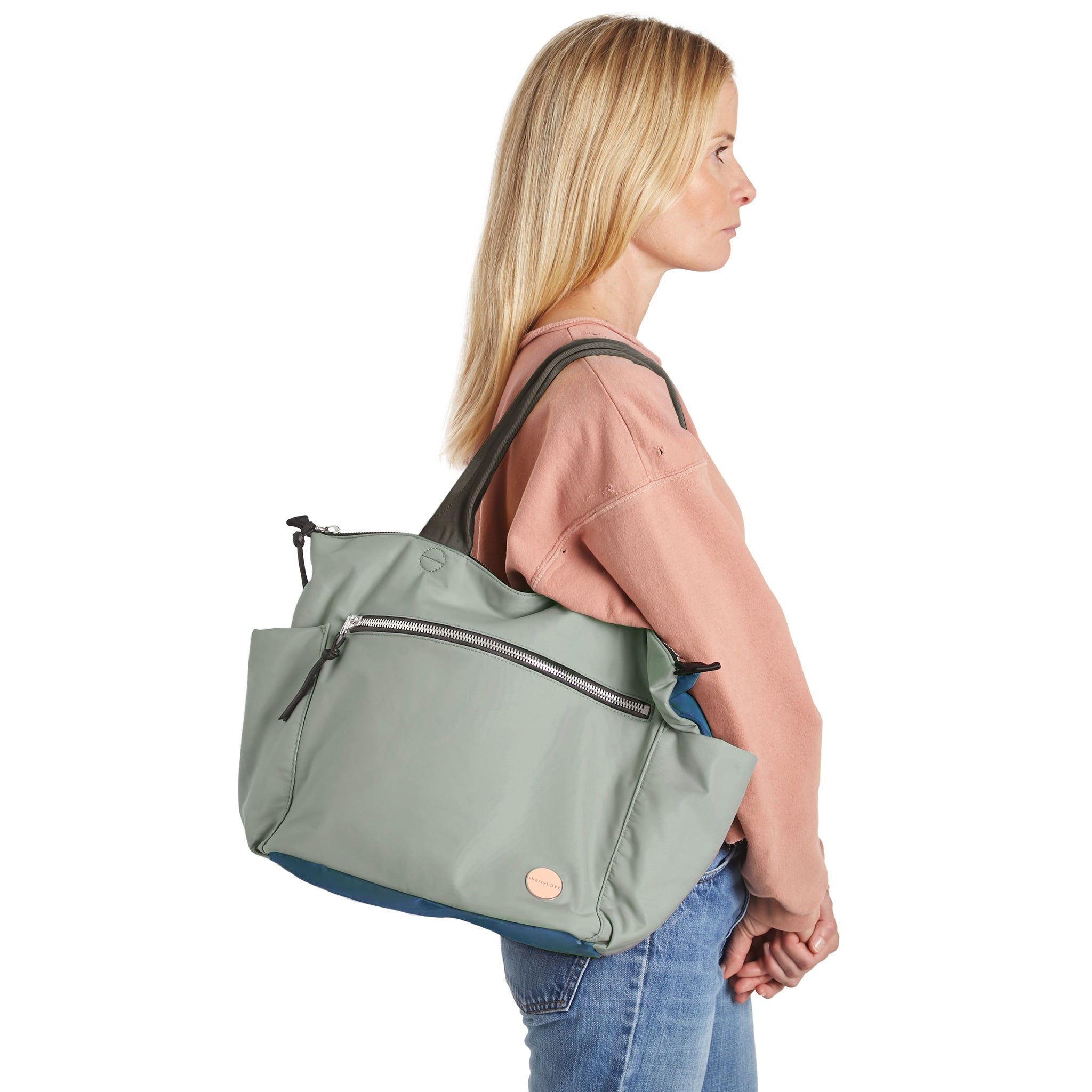 shortyLOVE tillie tote bag in slate/teal on model in jeans against white background.
