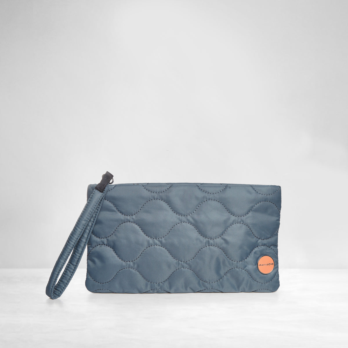 shortyLOVE cleo wristlet clutch in steel blue; front view against white background.