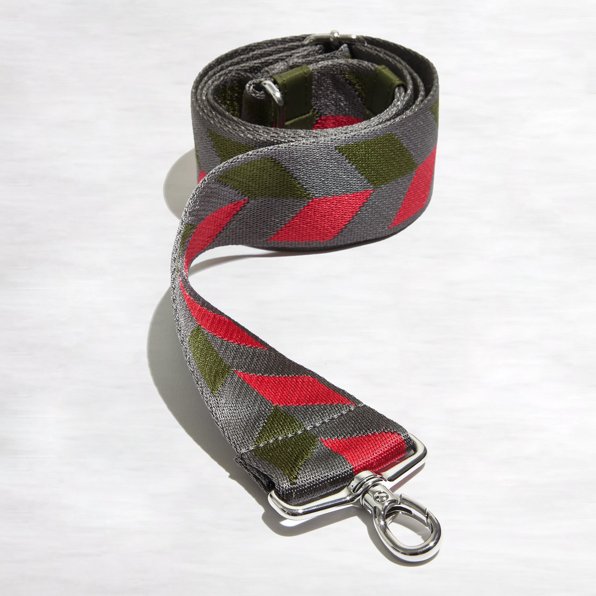 shortyLOVE boardwalk strap in arrow design in pewter/sage/magenta; front view rolled against white background.