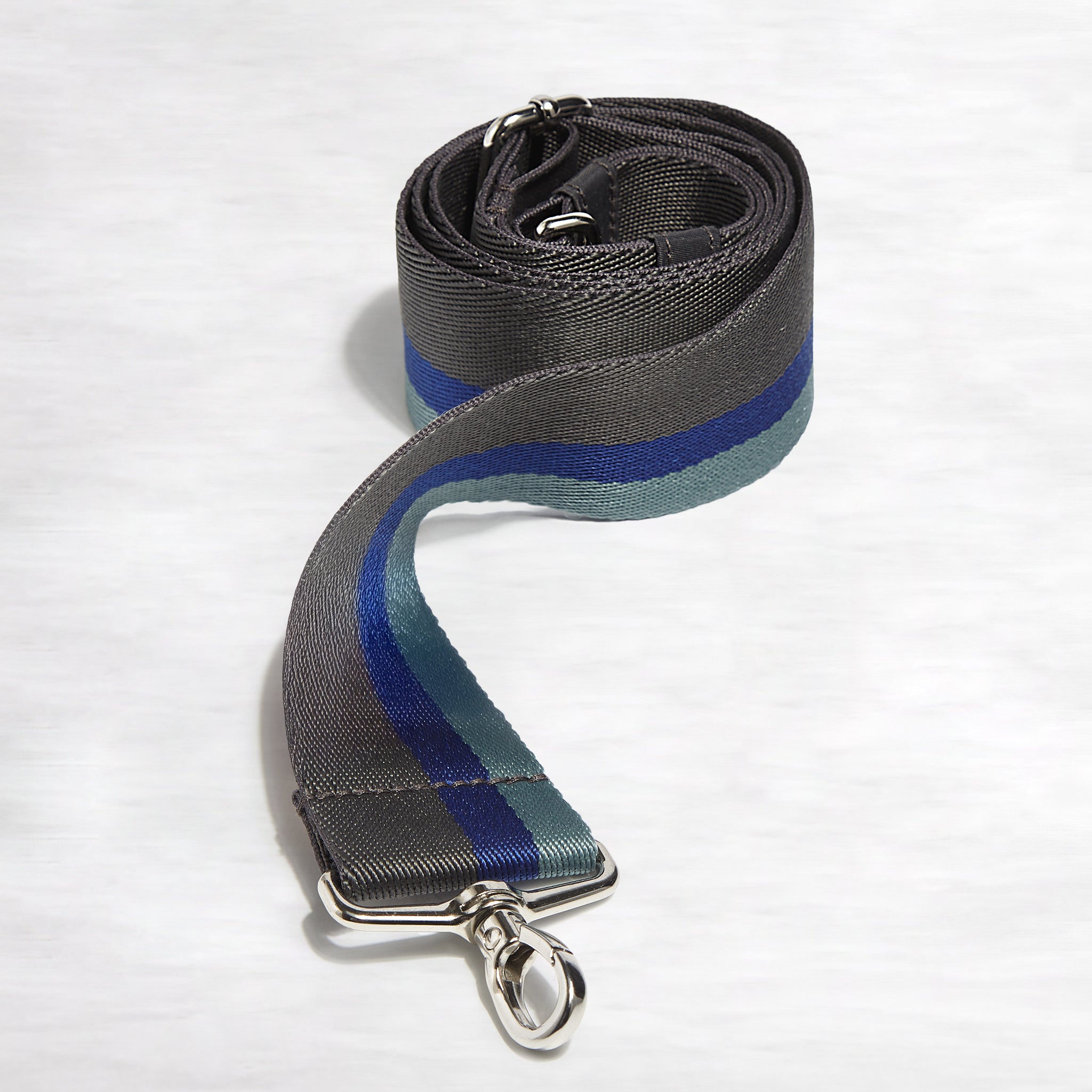 shortyLOVE boardwalk strap in charcoal/violet/steel; front view rolled against white background.