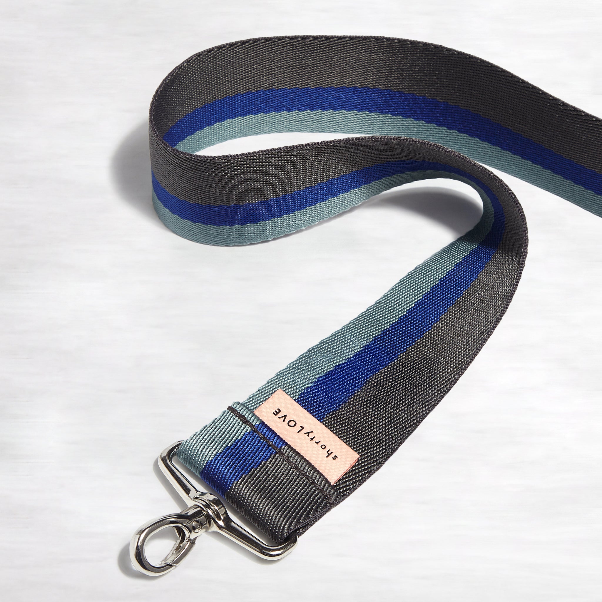 shortyLOVE boardwalk strap in charcoal/violet/steel; front view snaked against white background.