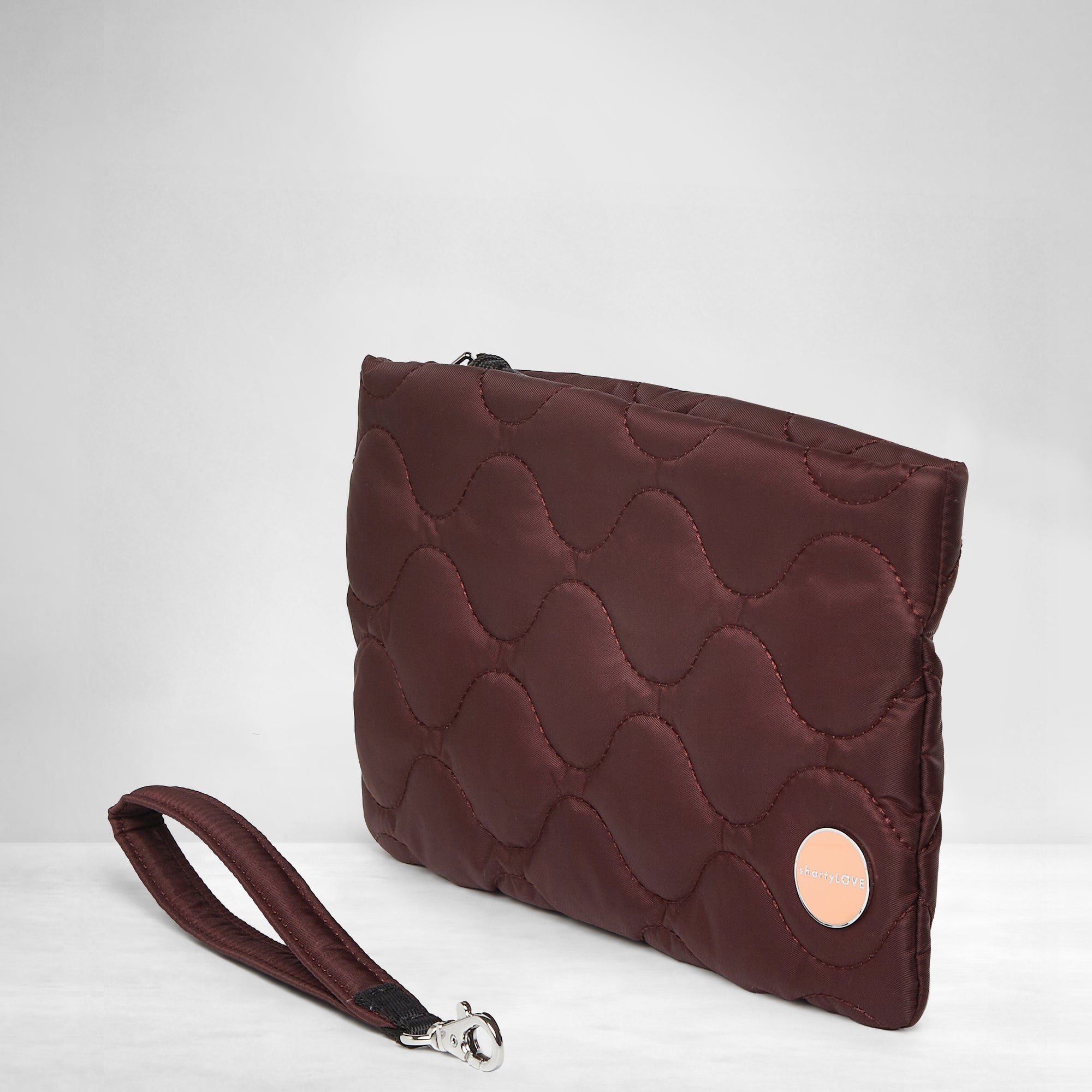 shortyLOVE cleo wristlet clutch in bordeaux; side view against white background.