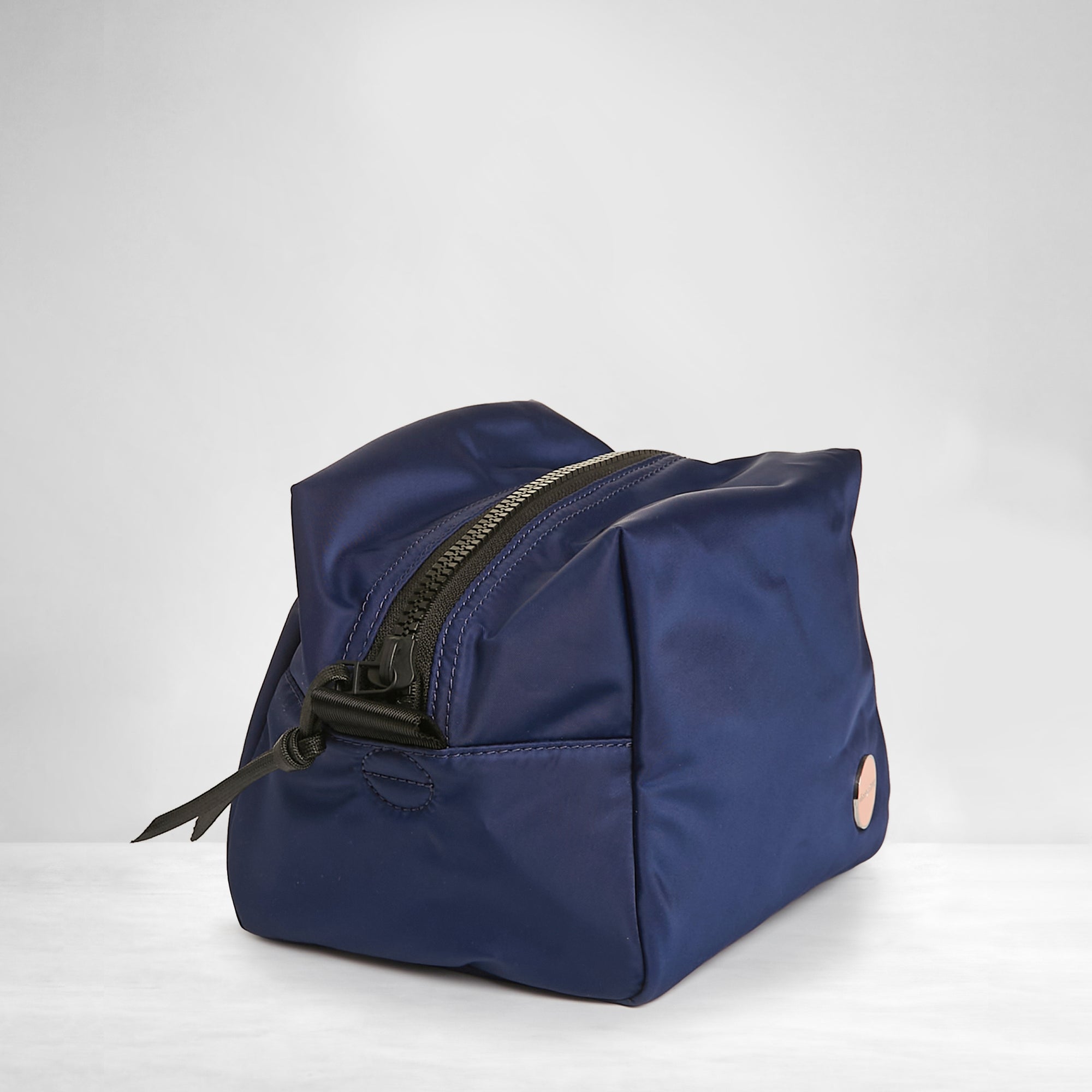 shortyLOVE stevie cosmetic bag in navy; side view against white background.
