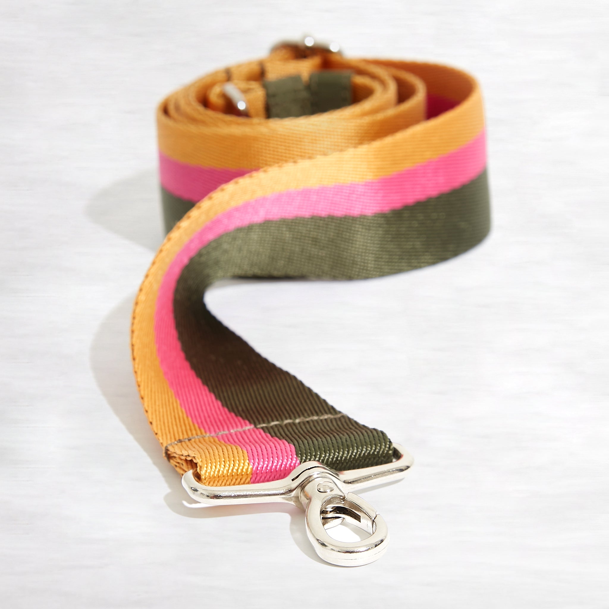 shortyLOVE boardwalk strap in green/yellow/fuchsia; front view rolled against white background.