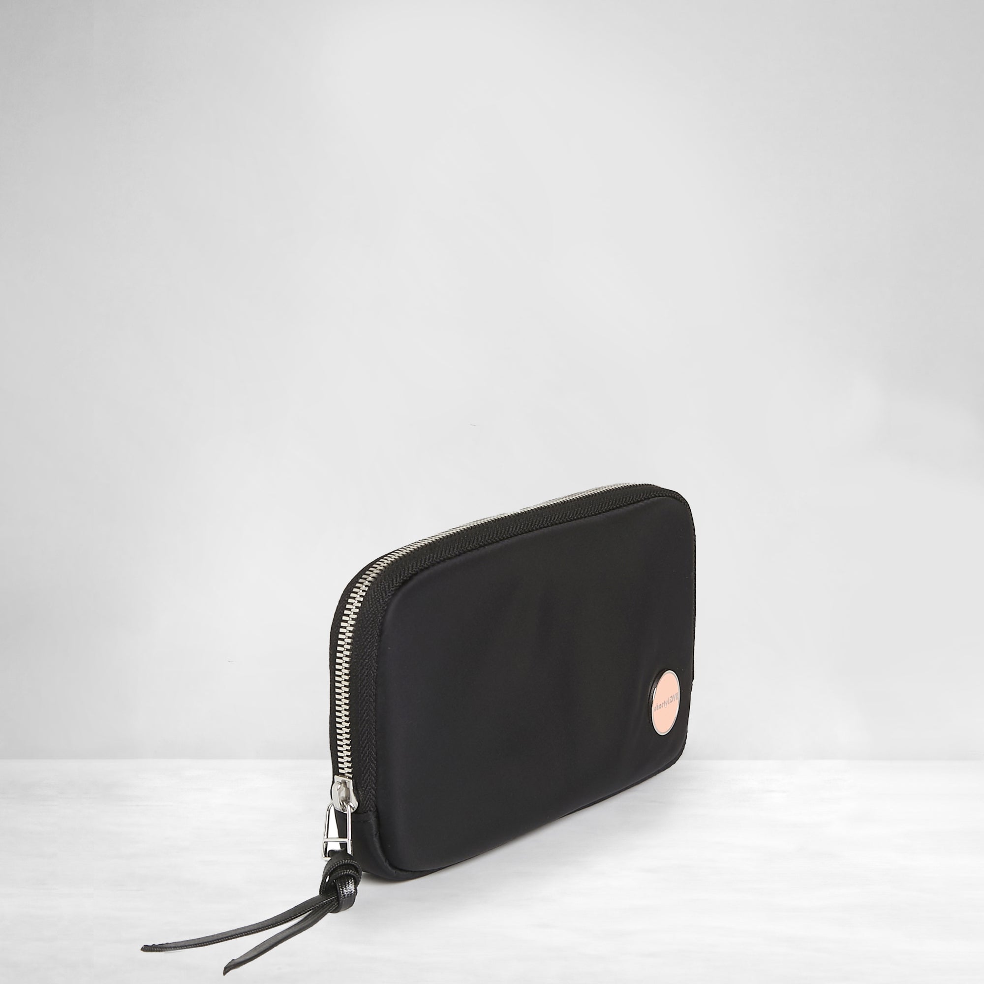 shortyLOVE jetty clutch/wallet in black; side angle view against white background.