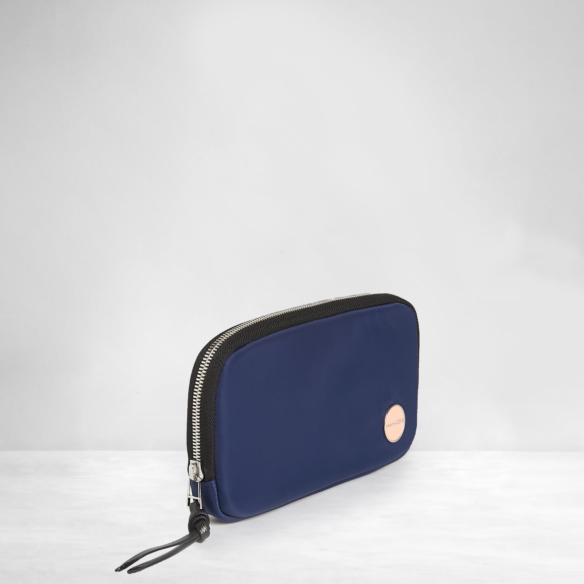 shortyLOVE jetty clutch/wallet in navy; side angle view against white background.