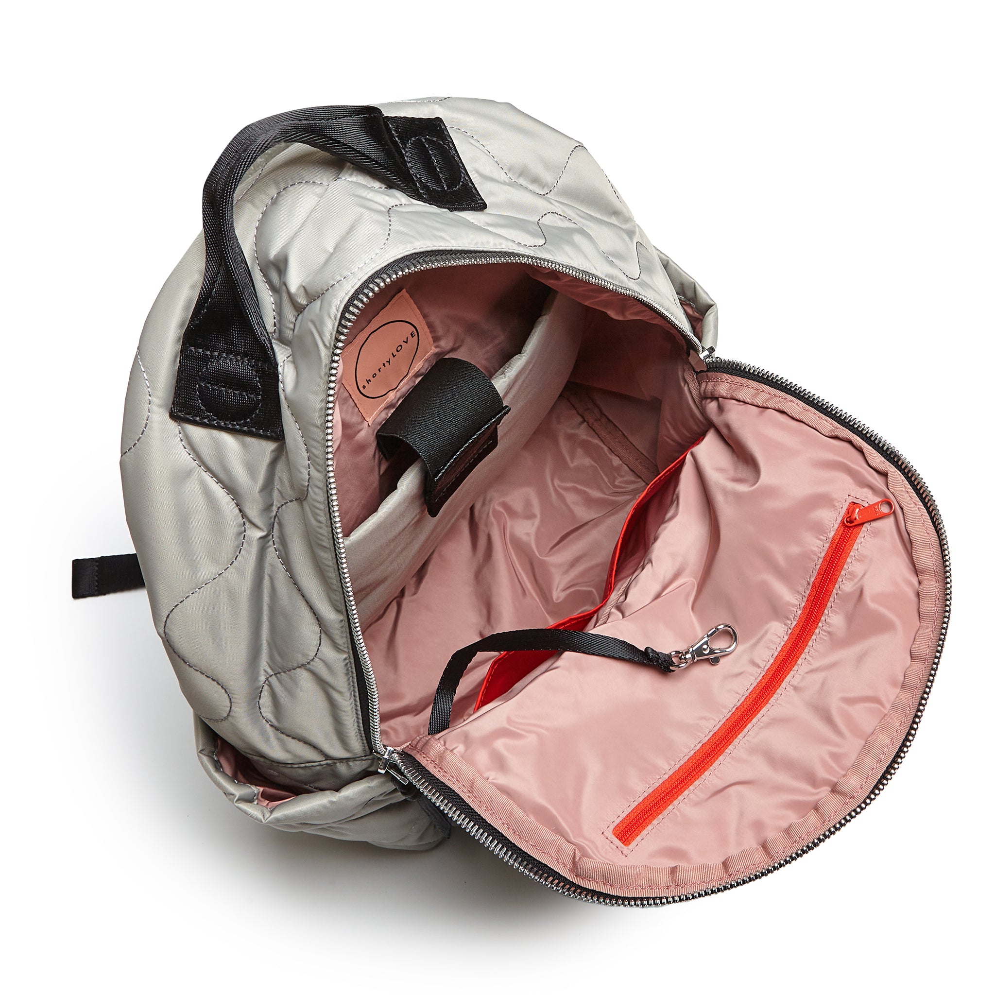 shortyLOVE tate backpack in milky grey; top-down view showing interior blush lining against white background.