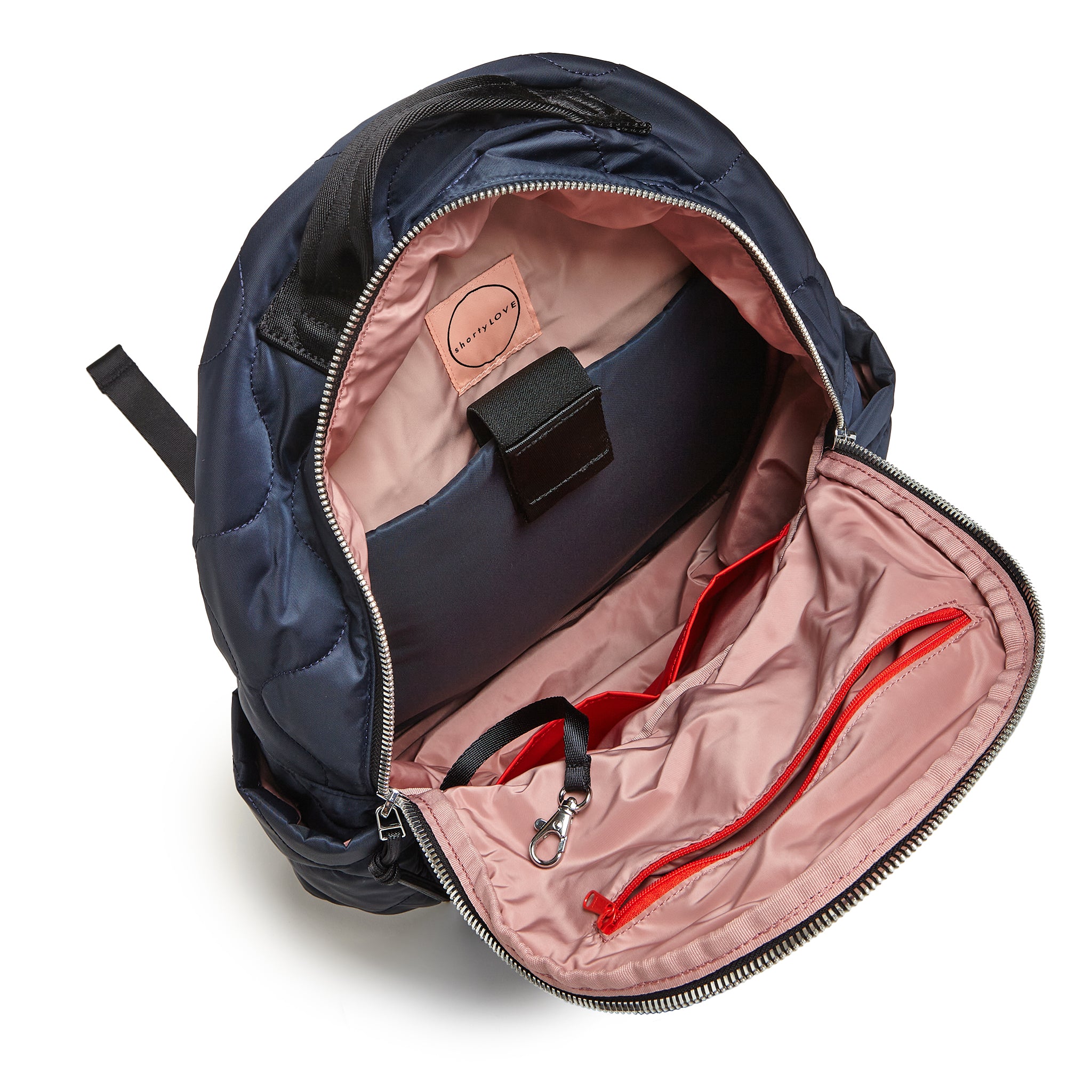 shortyLOVE tate backpack in midnight; top-down view showing interior blush lining against white background.