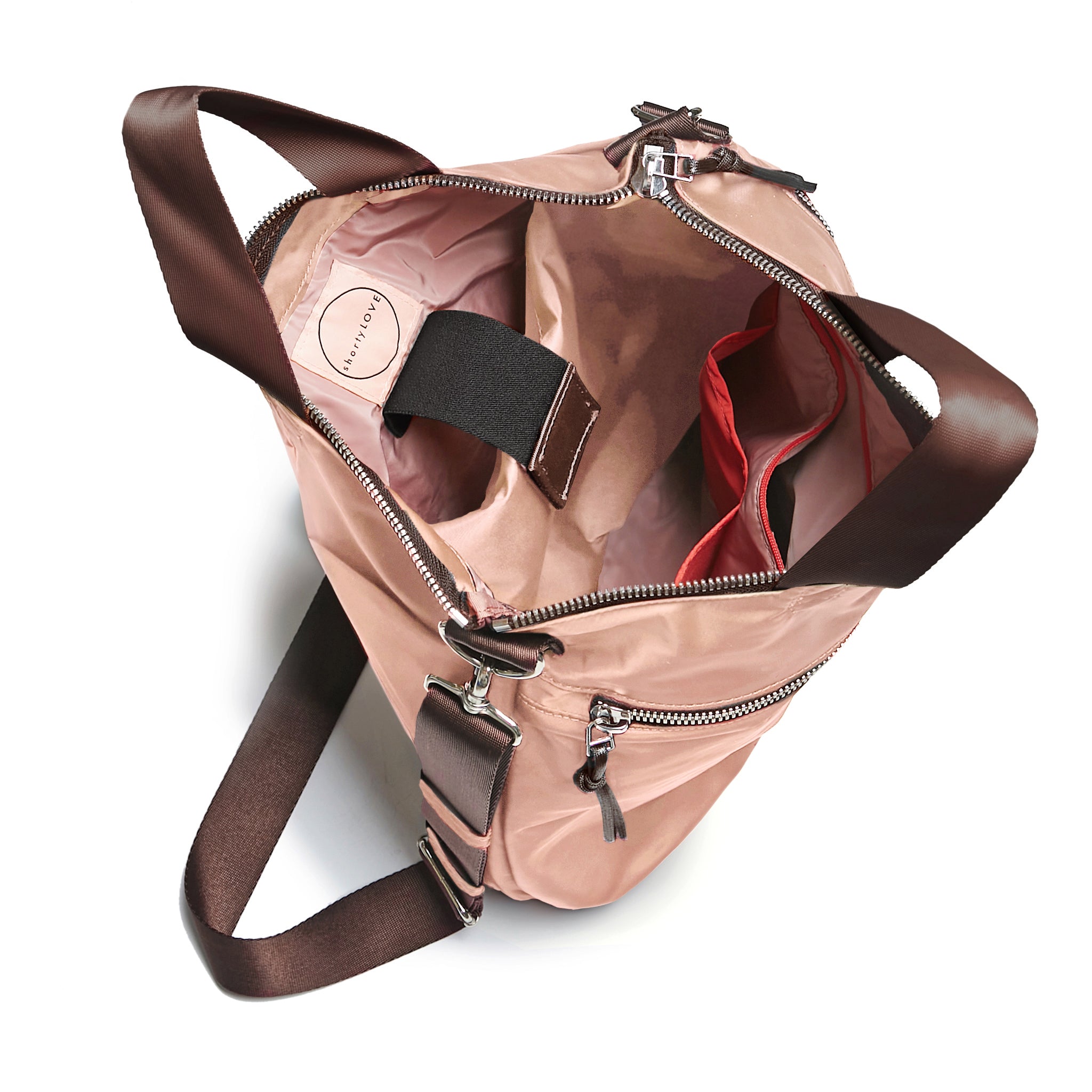 shortyLOVE wonder large crossbody/messenger bag in dusty peach; top-down view showing interior blush/red lining against white background.