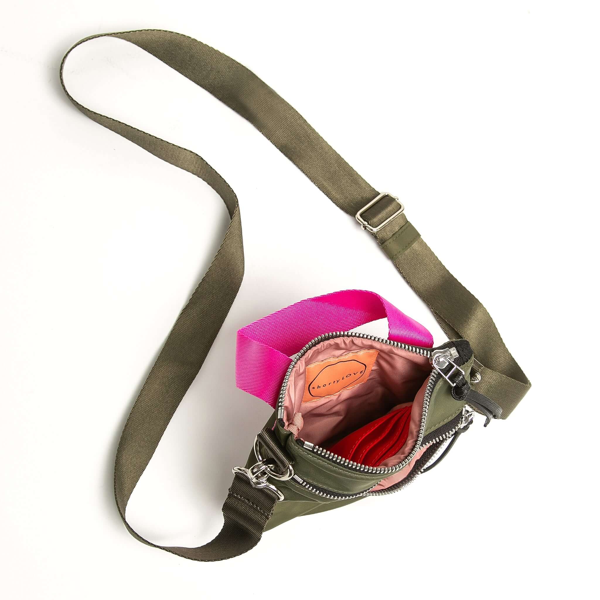 shortyLOVE shorthand crossbody phone bag in army green; top-down view showing interior pink lining against white background.