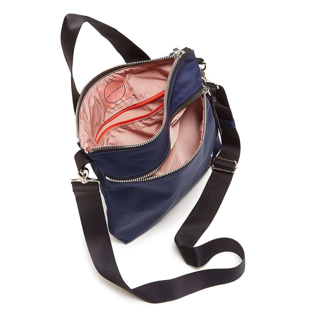shortyLOVE amuse medium sized crossbody bag in navy; top-down view showing interior pink lining against white background.