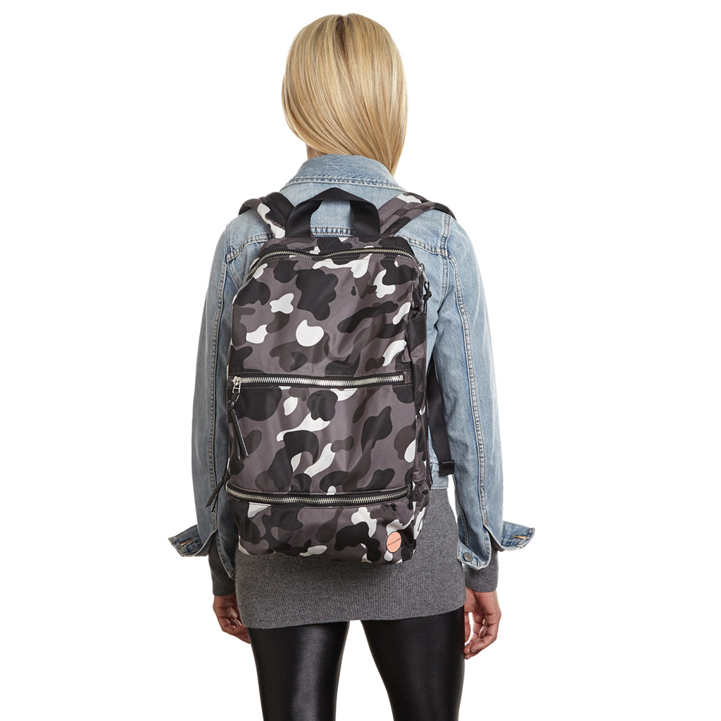 shortyLOVE boxer backpack in grey camo; on model on back in jean jacket and leggings against white background.