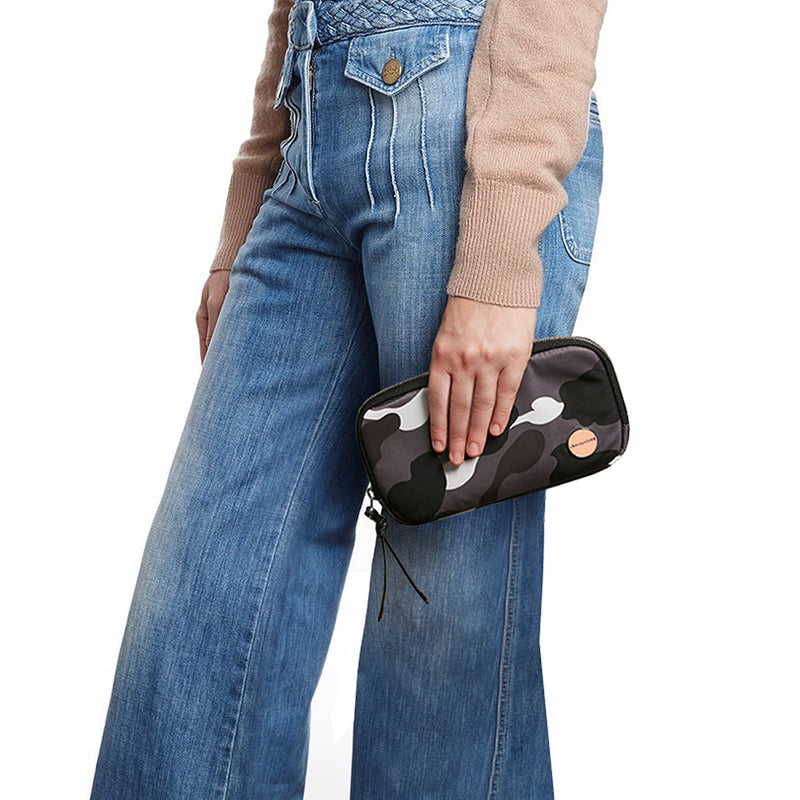 shortyLOVE jetty clutch/wallet in grey camo; hand held by model in jeans against white background.
