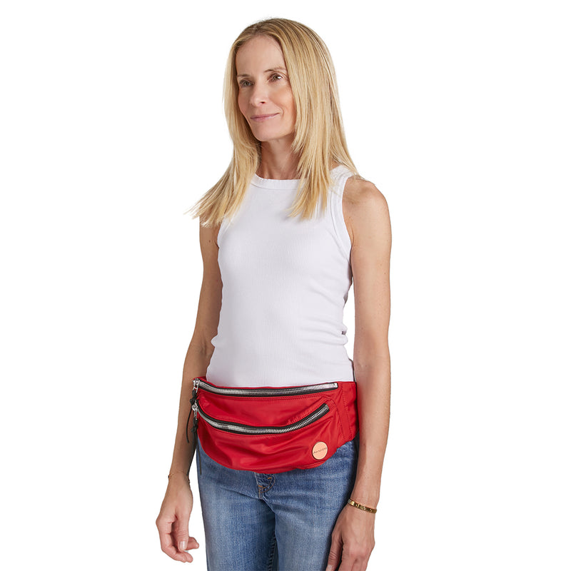 shortyLOVE arcade belt bag in red; on model worn as belt in white t-shirt and jeans against white background.