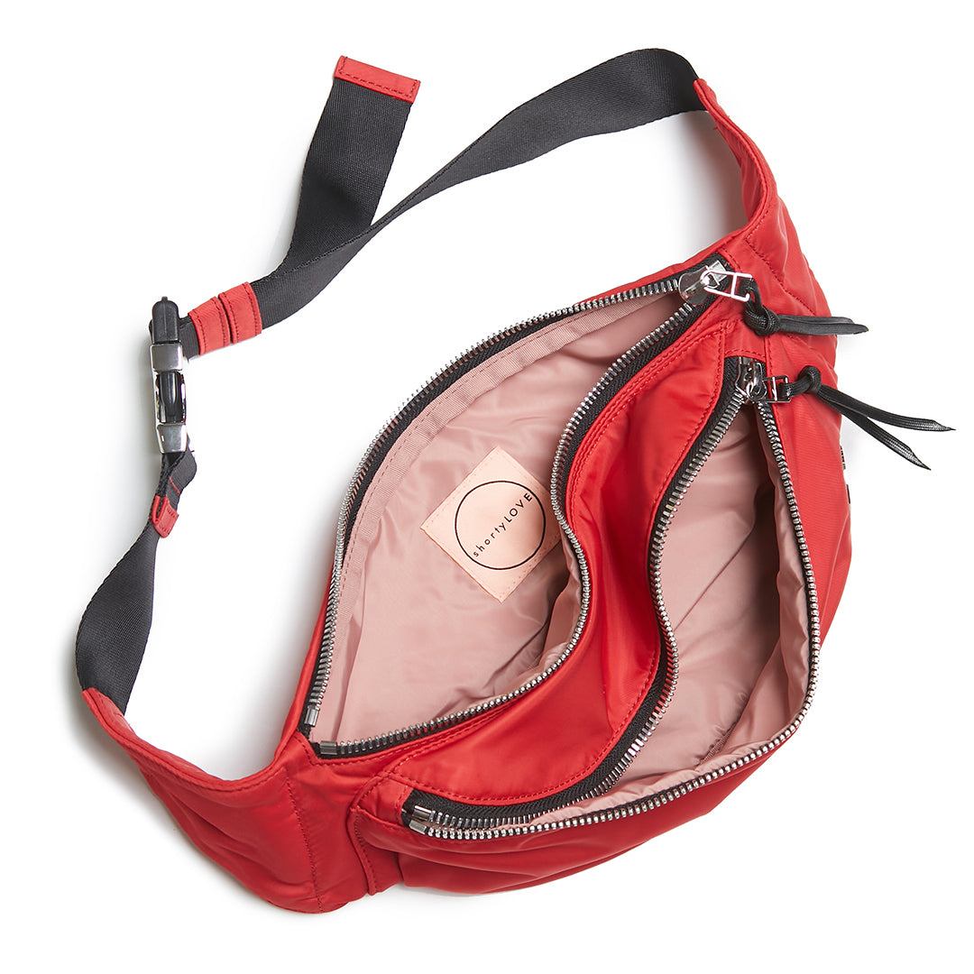 shortyLOVE arcade belt bag in red; top-down view showing interior blush lining against white background.