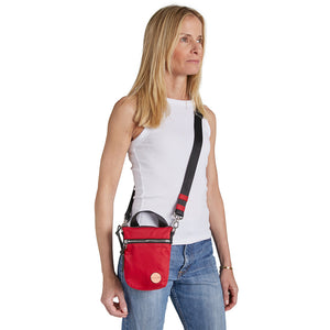 shortyLOVE shorthand small crossbody bag in red; on model in white t-shirt and jeans against white background.