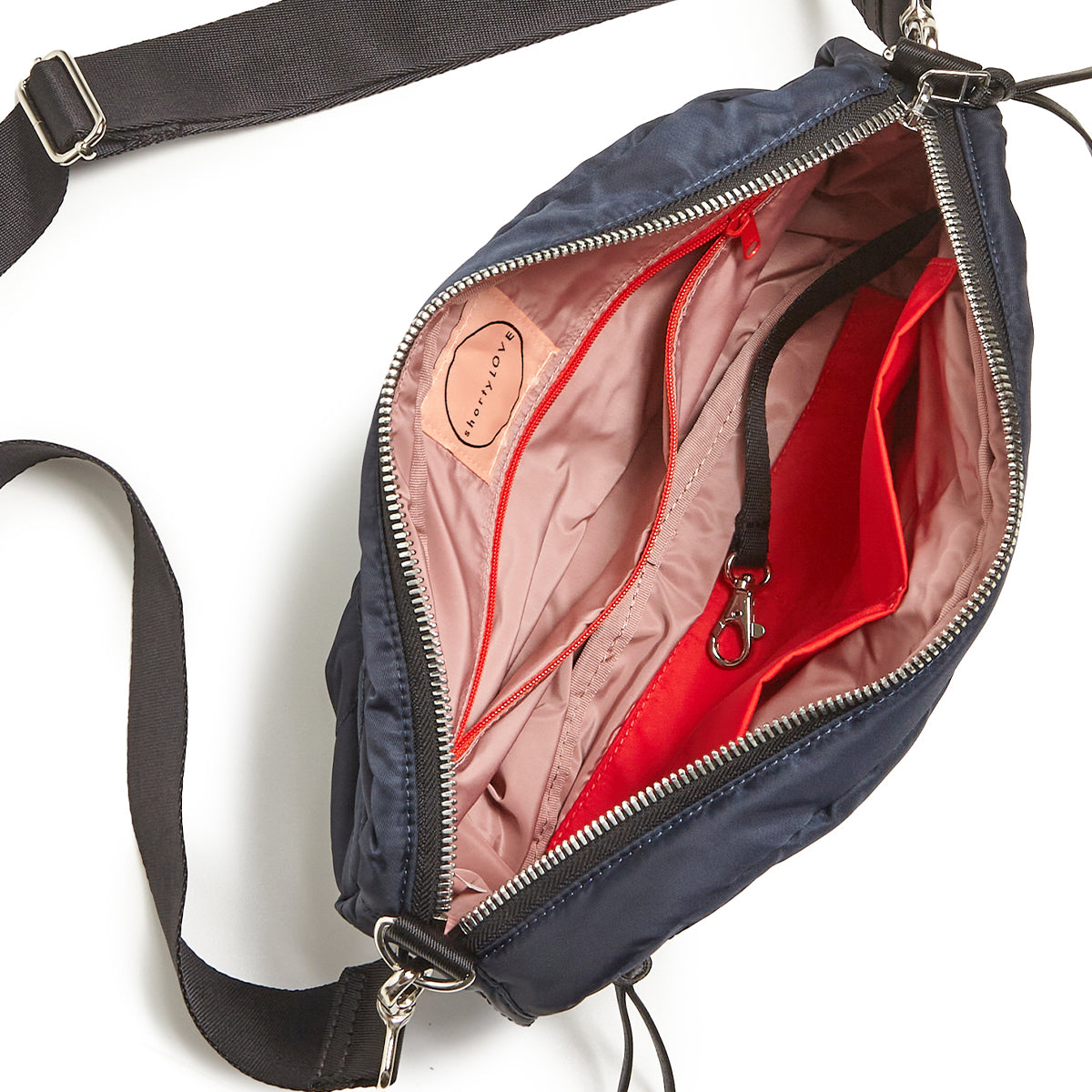 Midnight navy blue bag with blush interior on a white background