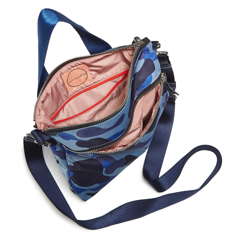 shortyLOVE amuse medium sized crossbody bag in blue camo; top-down view showing interior blush lining against white background.