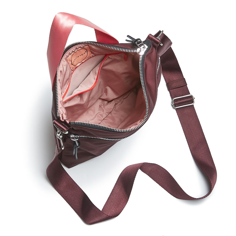 shortyLOVE amuse medium sized crossbody bag in burgundy; top-down view showing interior blush/red lining against white background.