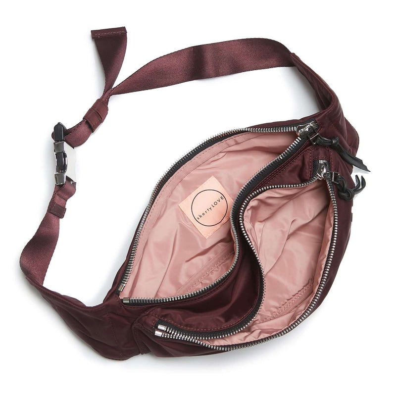 shortyLOVE arcade belt bag in burgundy; top-down view showing interior pink lining against white background.