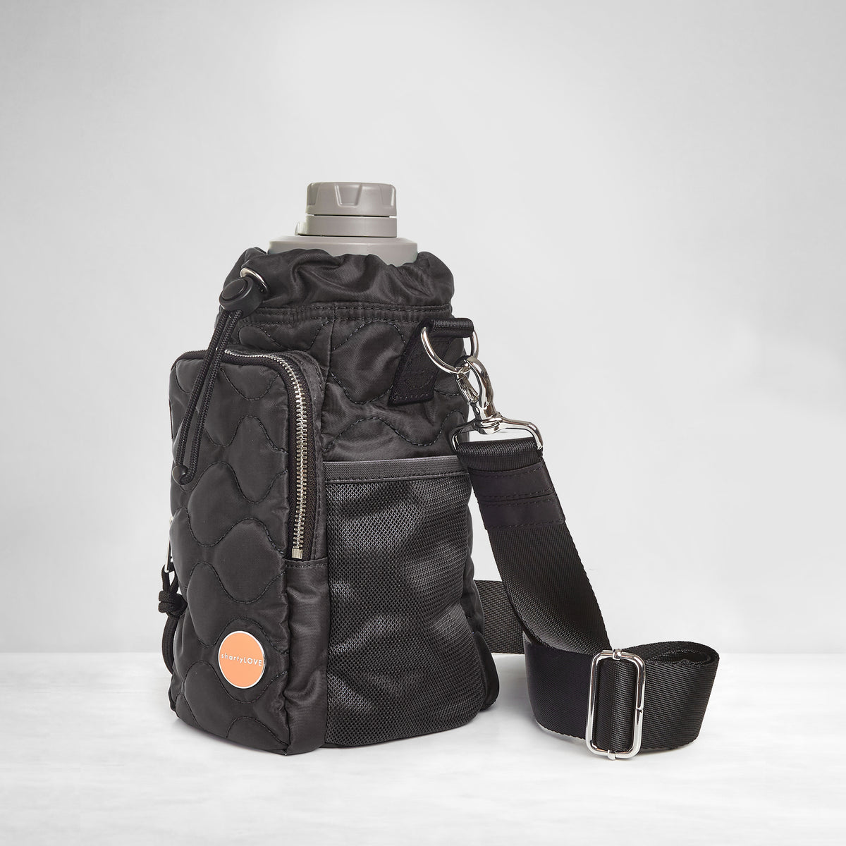 shortyLOVE bea sling bag in black; side view against grey background.